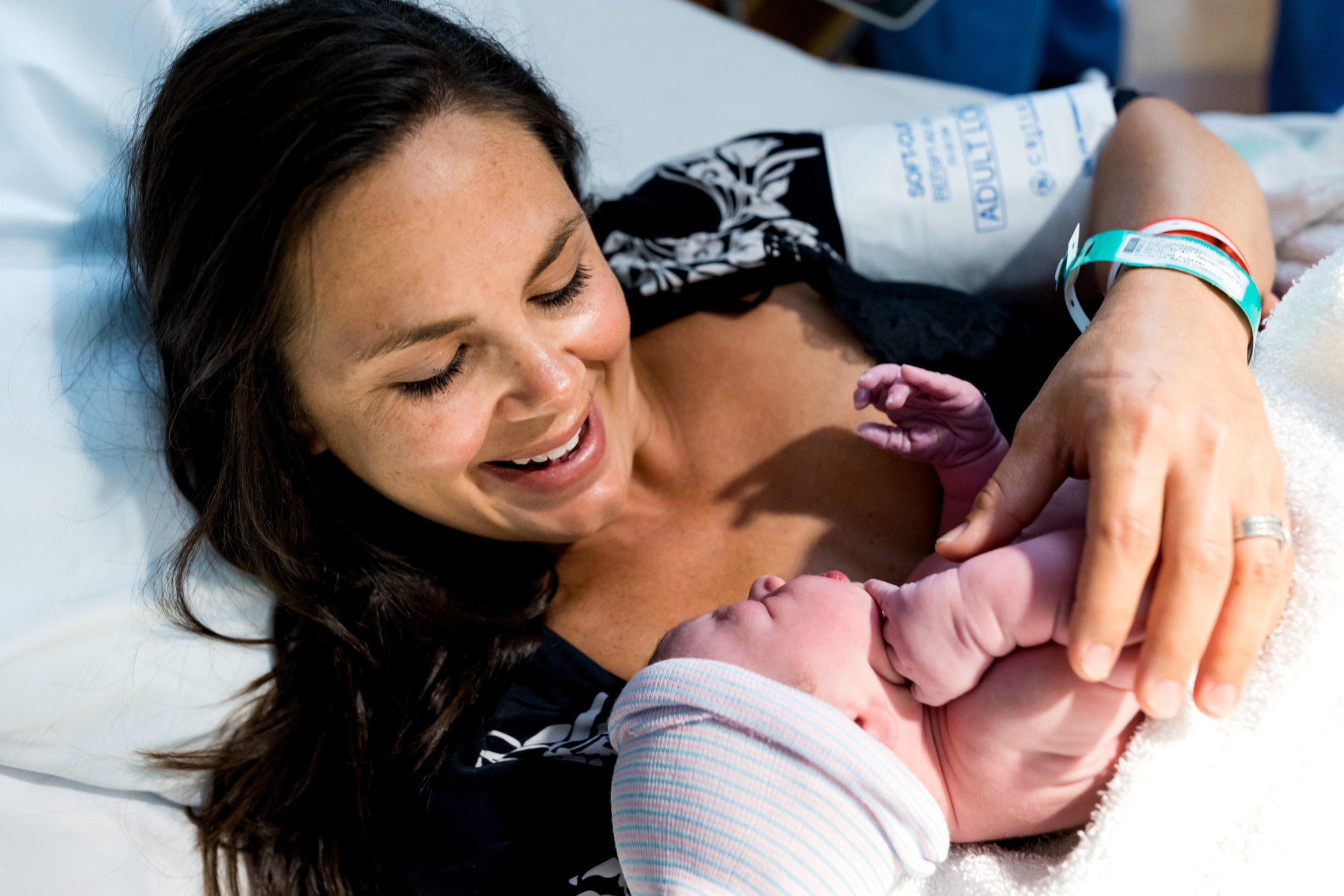 birth mom admiring her newborn baby girl