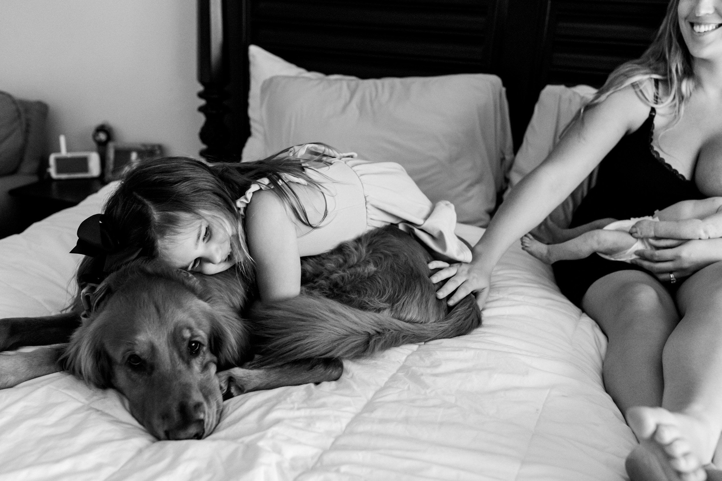 little girl hugging her dog