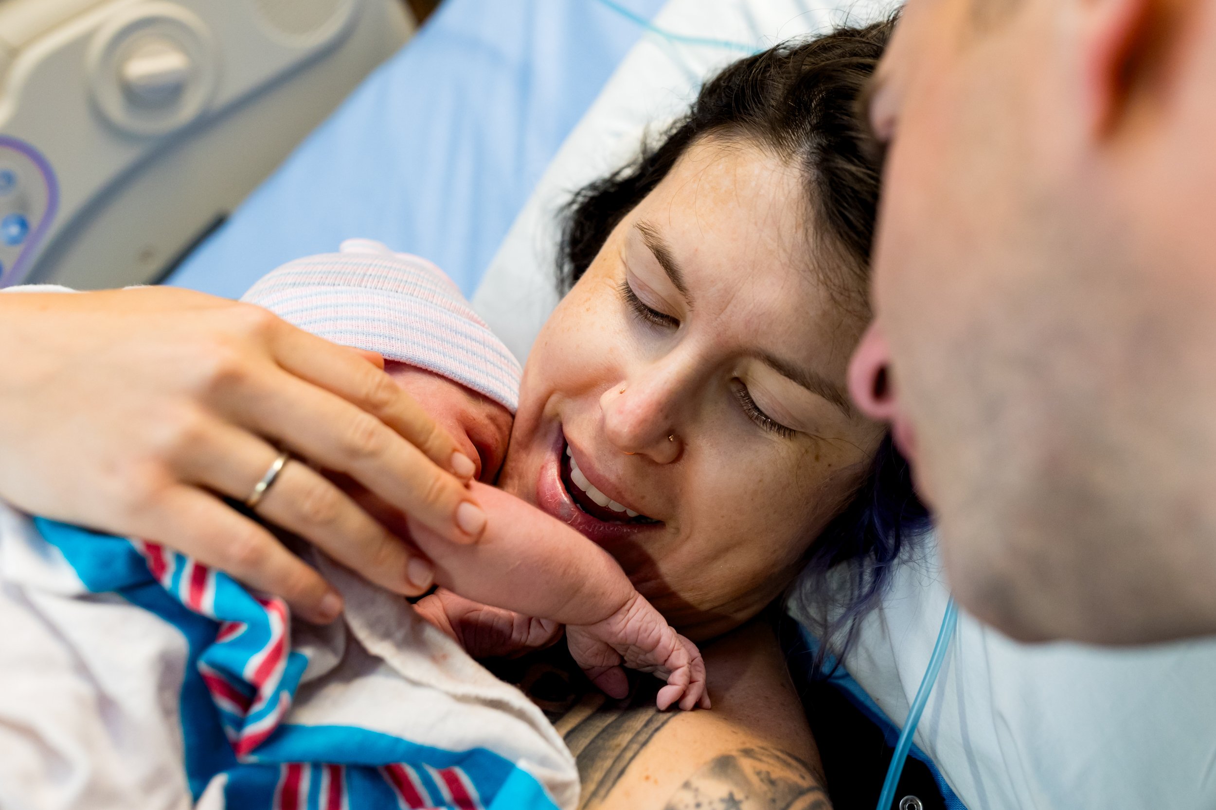 mom looking at her newborn baby just after birth