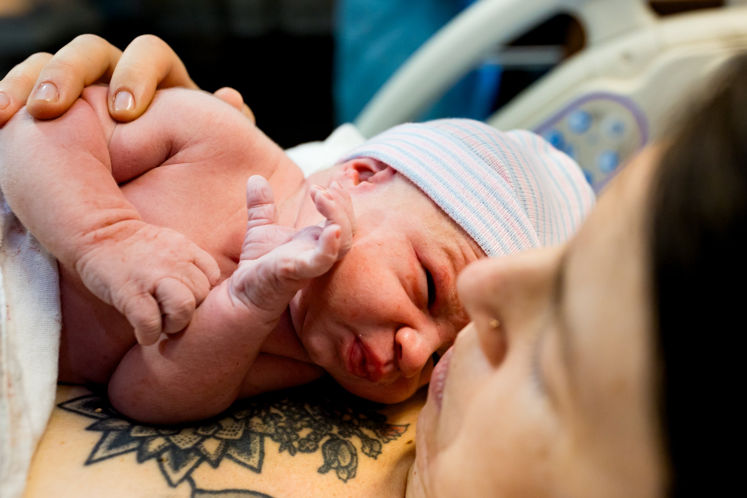 newborn baby resting on mom's chest just after birth