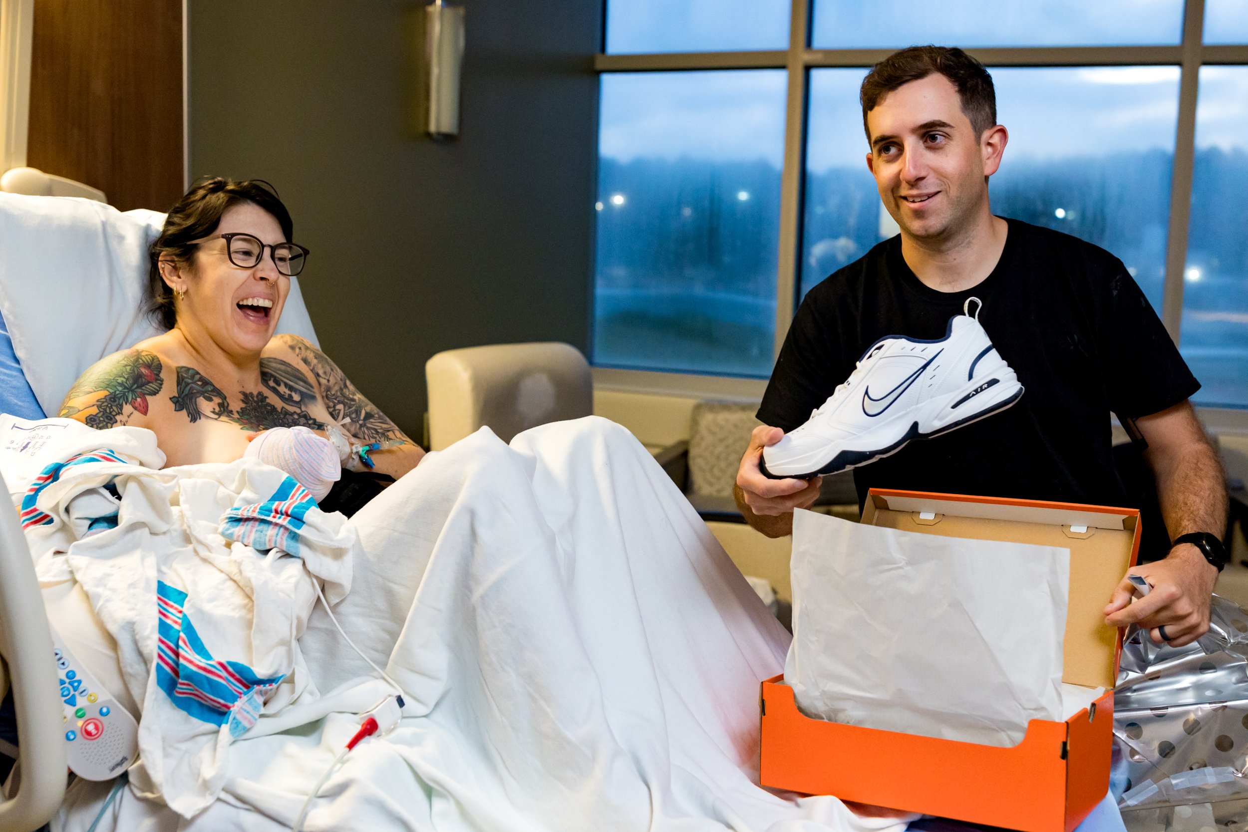 new dad receiving "dad shoes" in the hospital just after baby's birth
