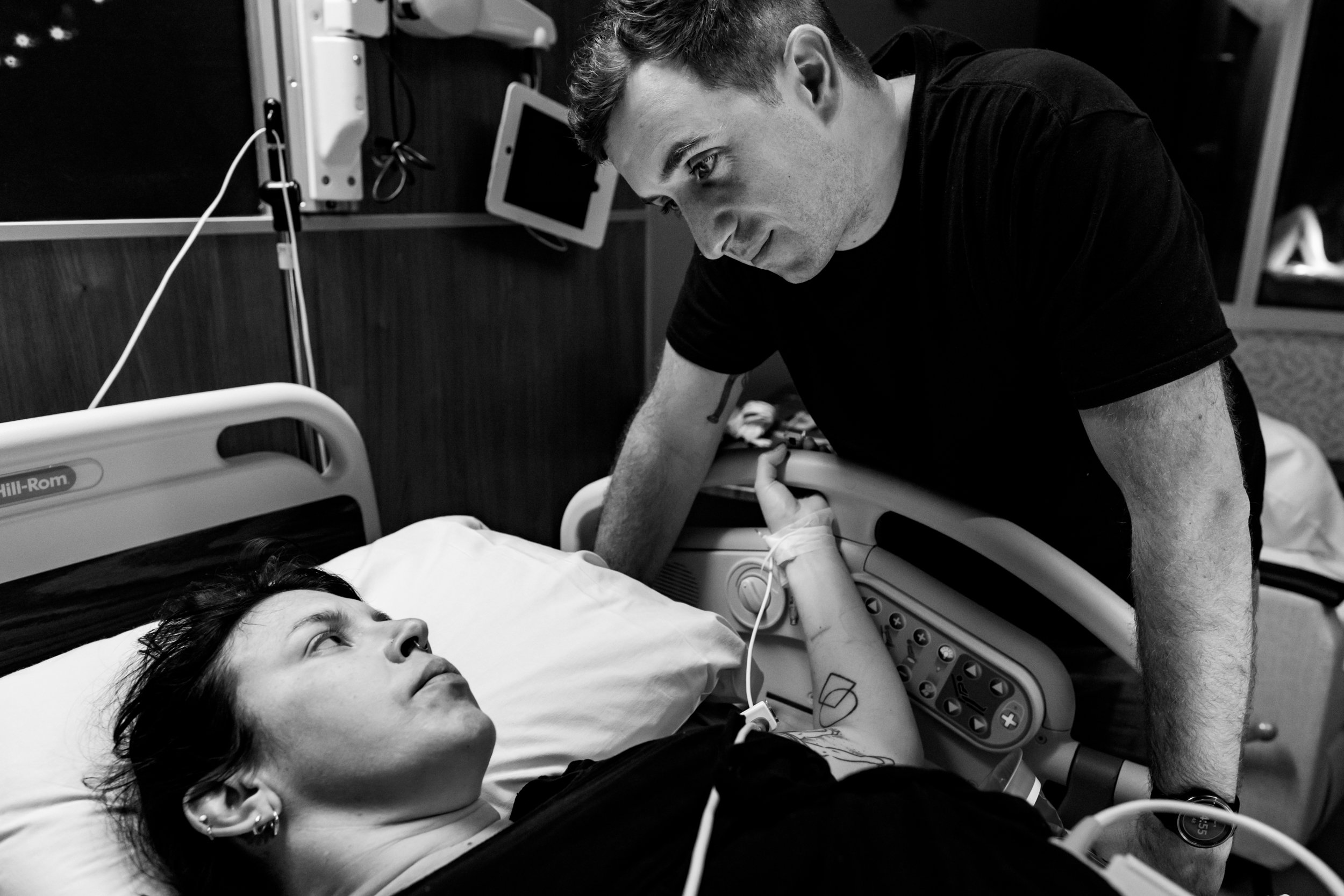 husband looking longingly at his wife just before the birth