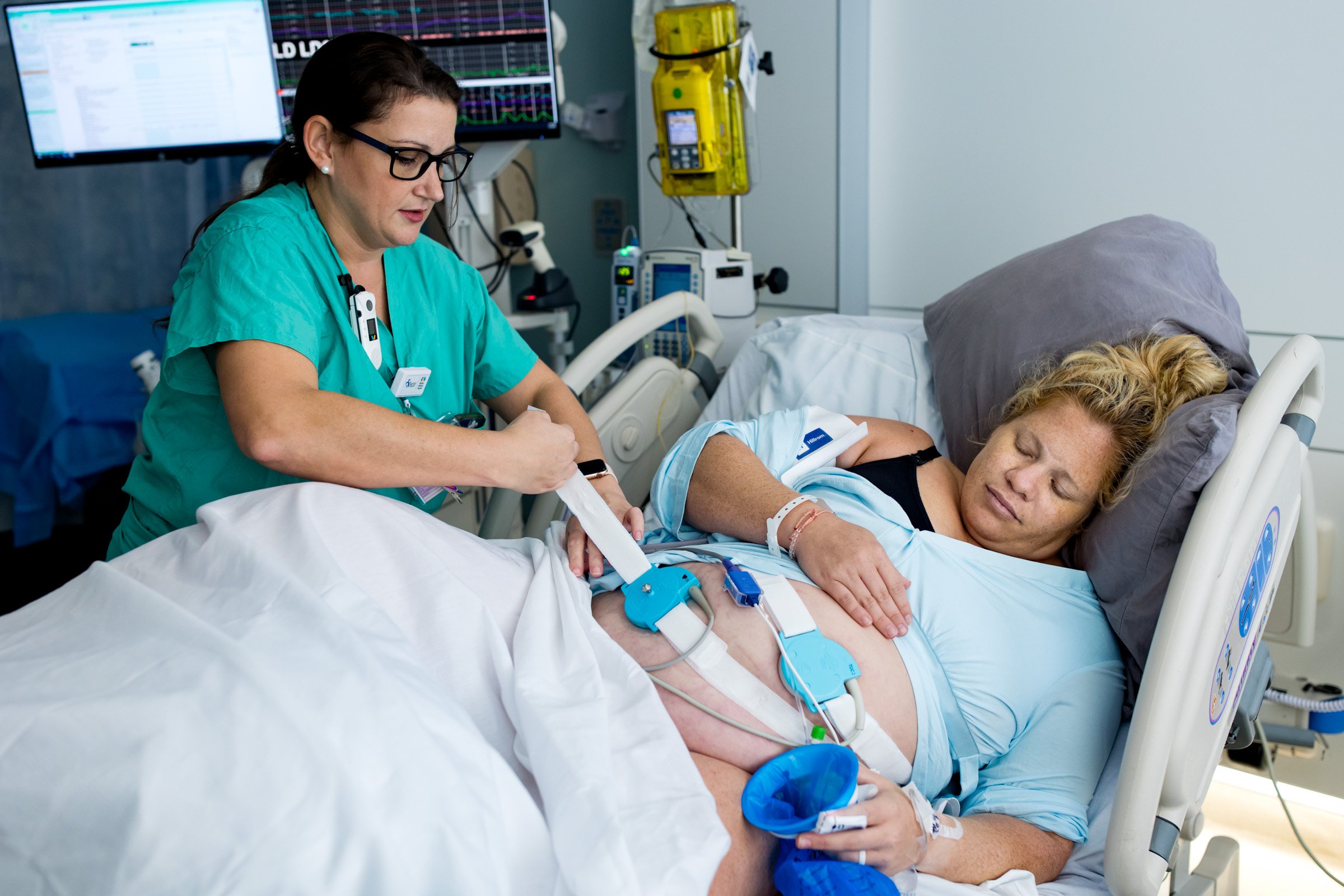 nurse adjusting pregnant mom's monitors