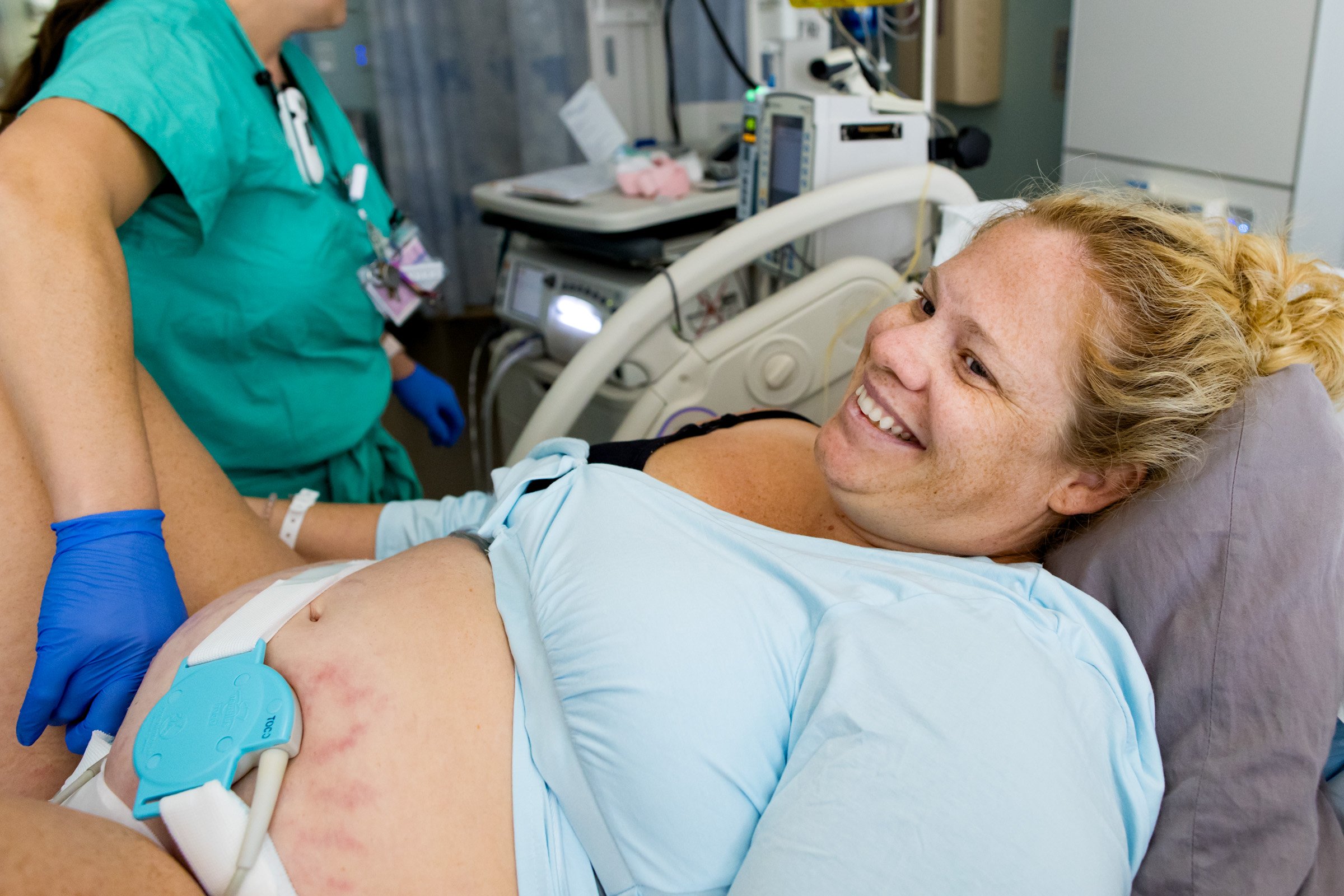 birth mom smiling at husband in between contractions