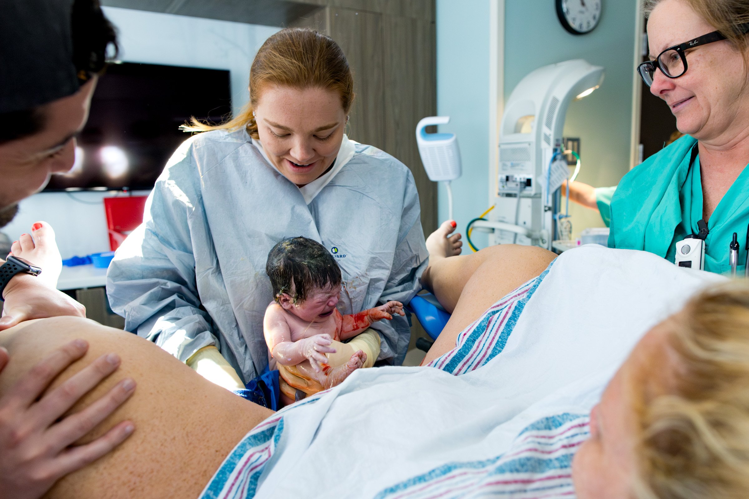 doctor holding baby just after birth