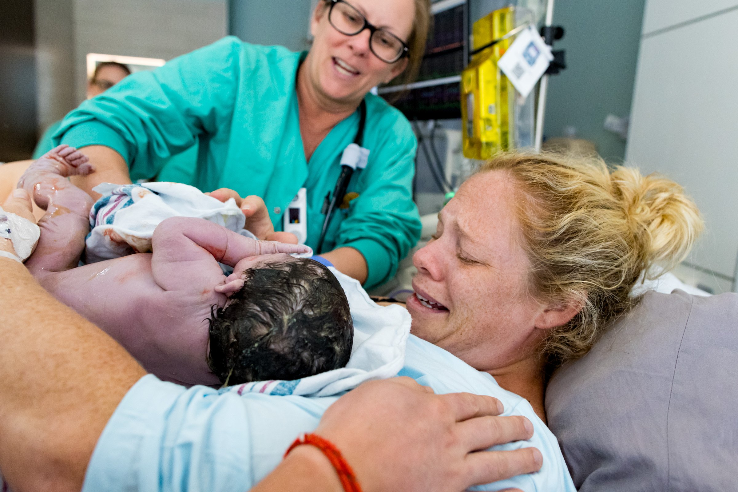 jacksonville mom crying as she receives her baby just after birth