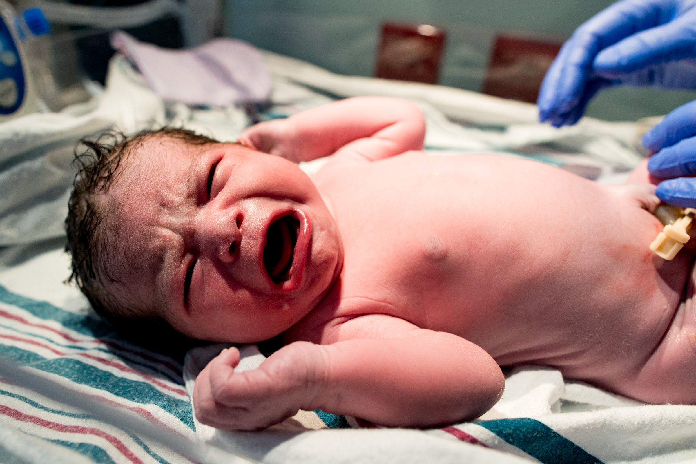 newborn baby crying in the warmer