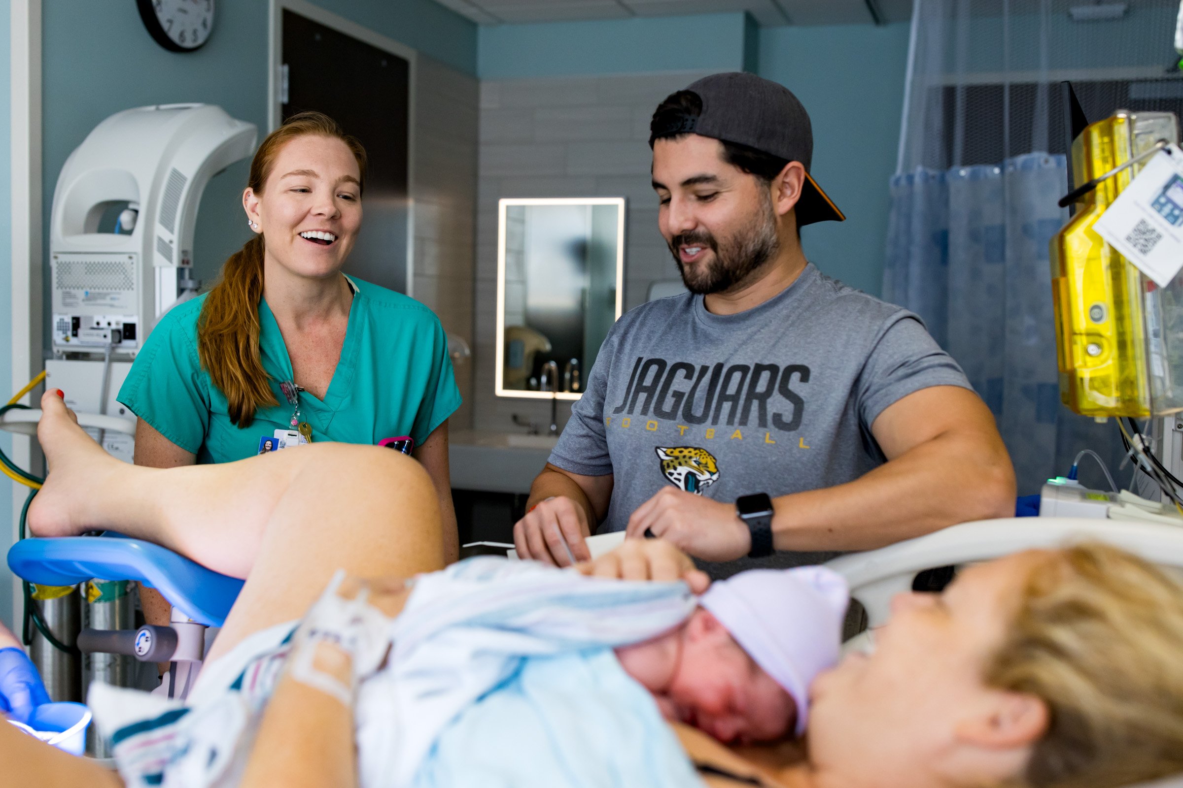 ob/gyn laughing with new parents
