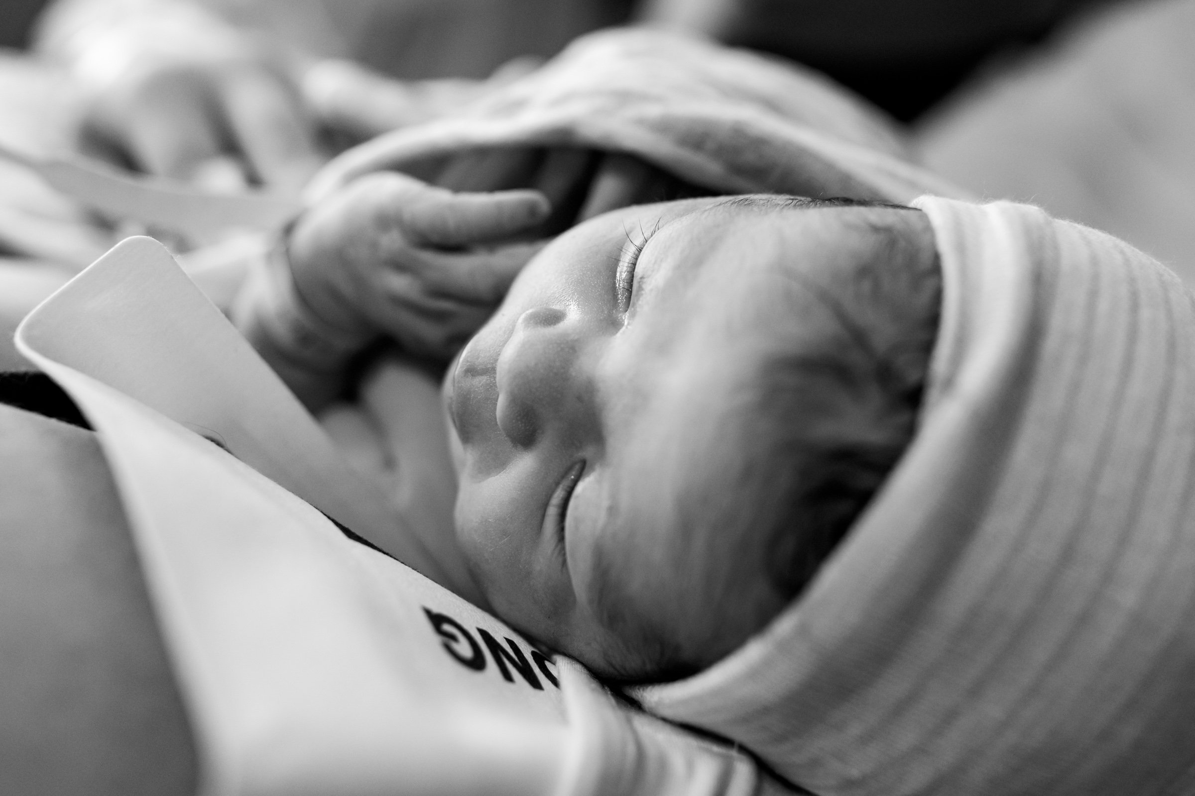 black and white image of newborn baby showing her features