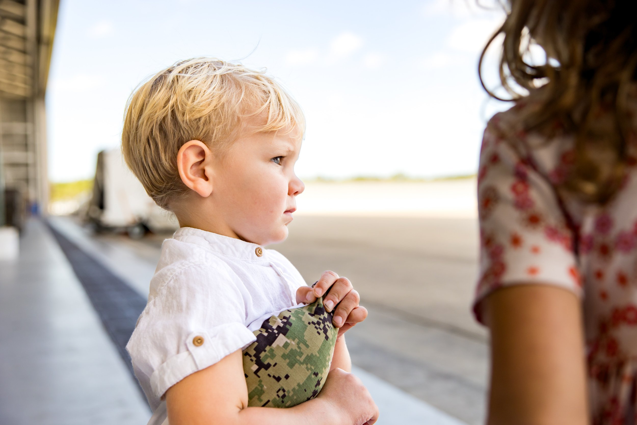 little boy hugging his pillow picturing his dad while waiting for him to arrive