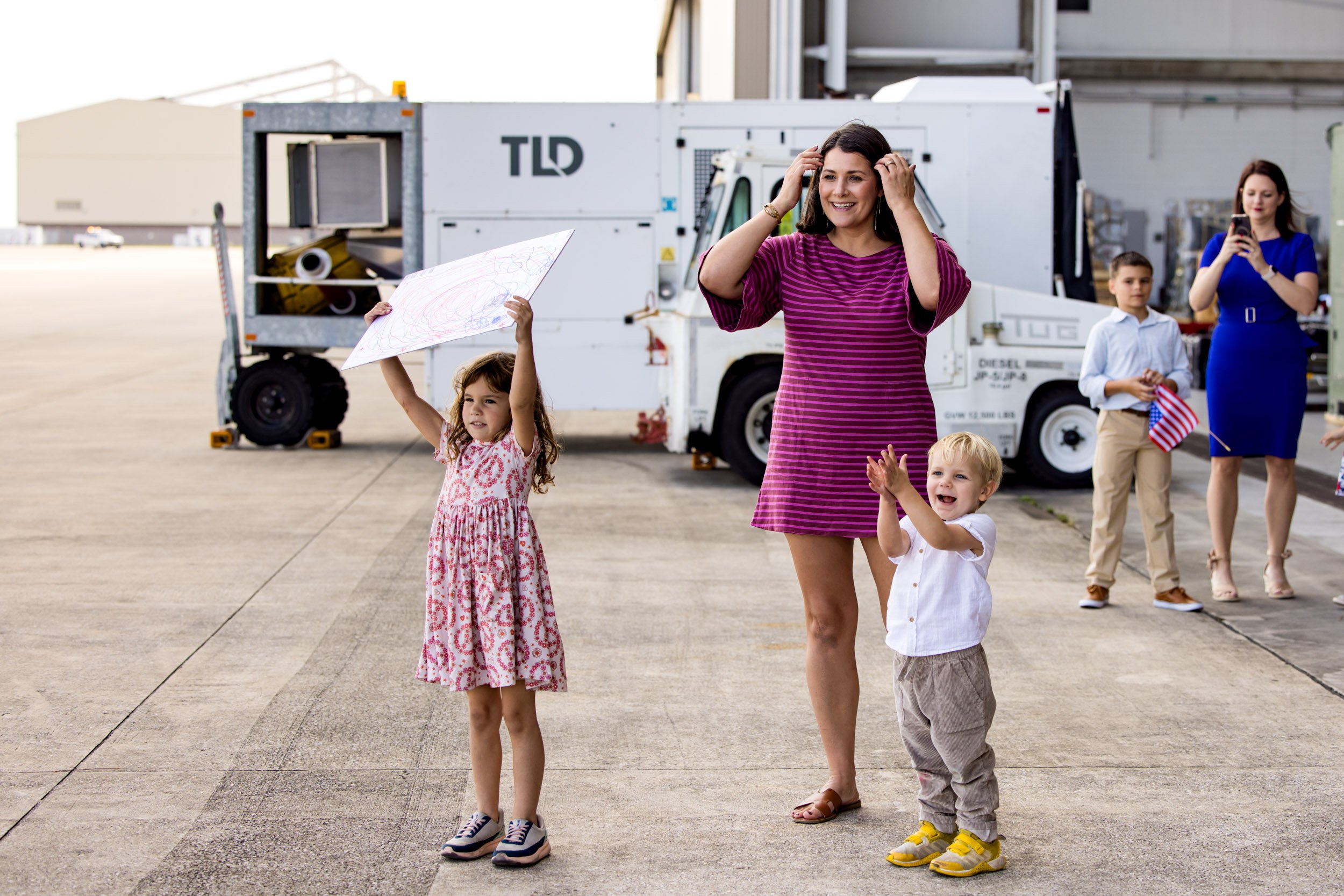 family excitedly watching dad to fly in for military homecoming