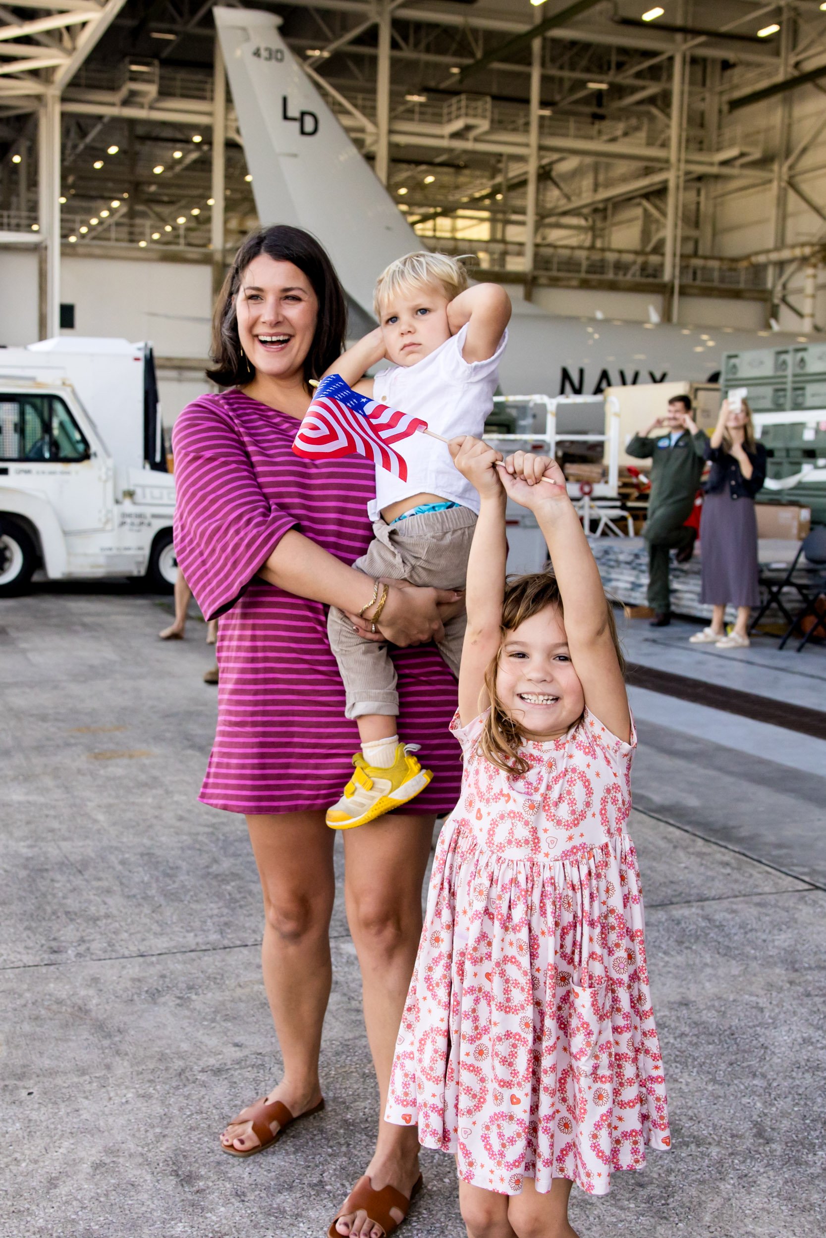 family excitedly watching dad to fly in for military homecoming