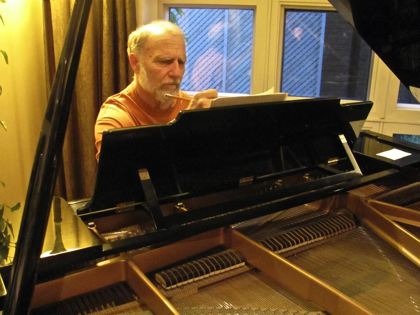 Composing another piece at his piano