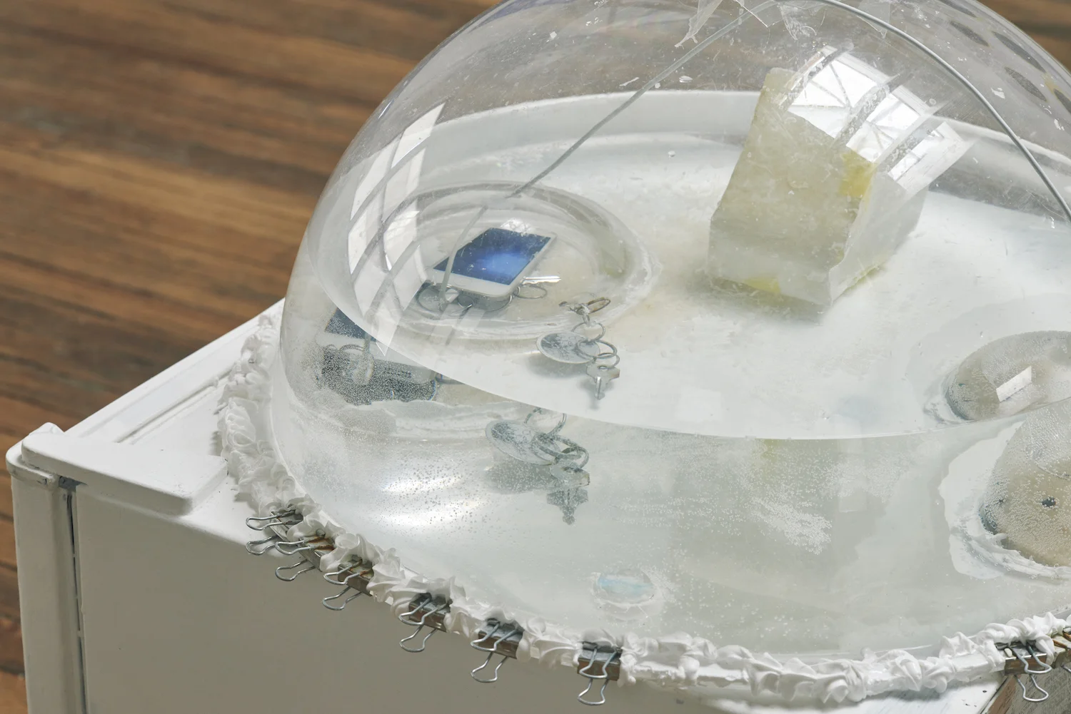 Willard Klein Ghost Town Preservation , 2018 Aquarium parts, wax, natural paper, fish hook, iPhone and charger, silicone, binder clips, water and painted refrigerator