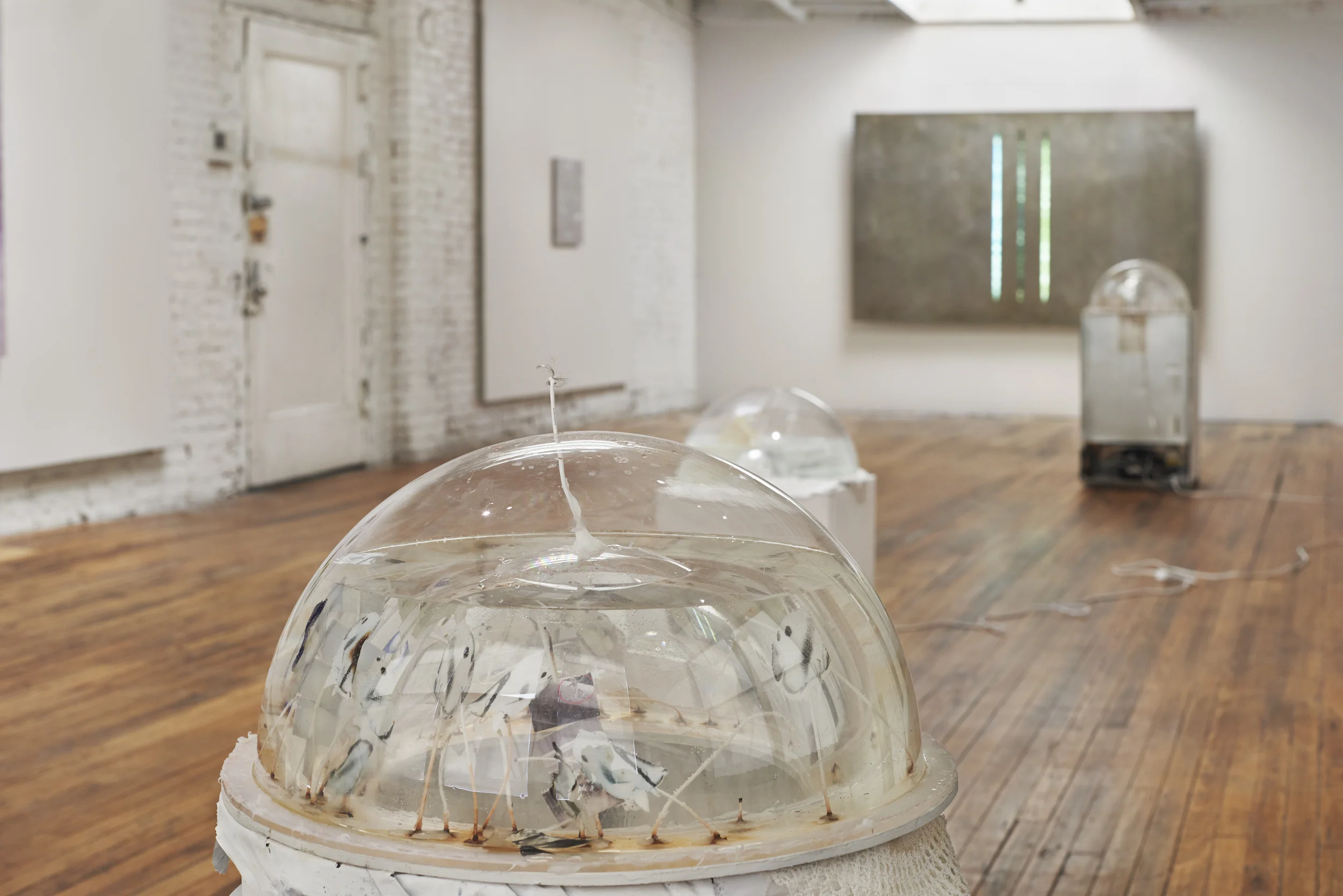 Willard Klein Tropical Aquarium, Deciduous Biome , 2018 Wax, natural paper, candle wicks, bleach, water, phone parts, plastic, painted rubber trash can, silicone