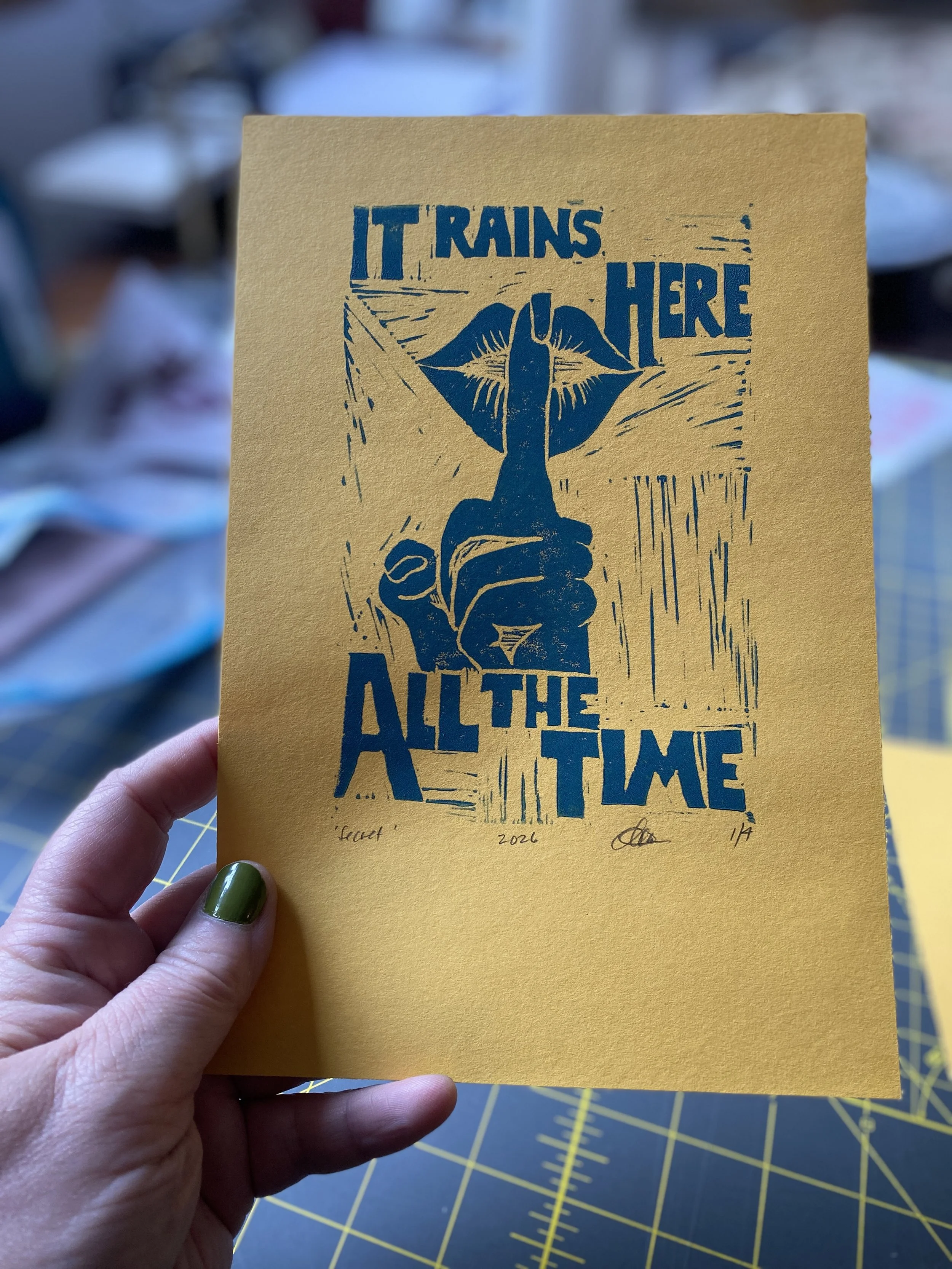 it rains here all of the time pnw pacific northwest art secret tourists it's sunny all of the time block print plum yellow blue lips shhhhhhhhh shush can you keep a secret don't say anything