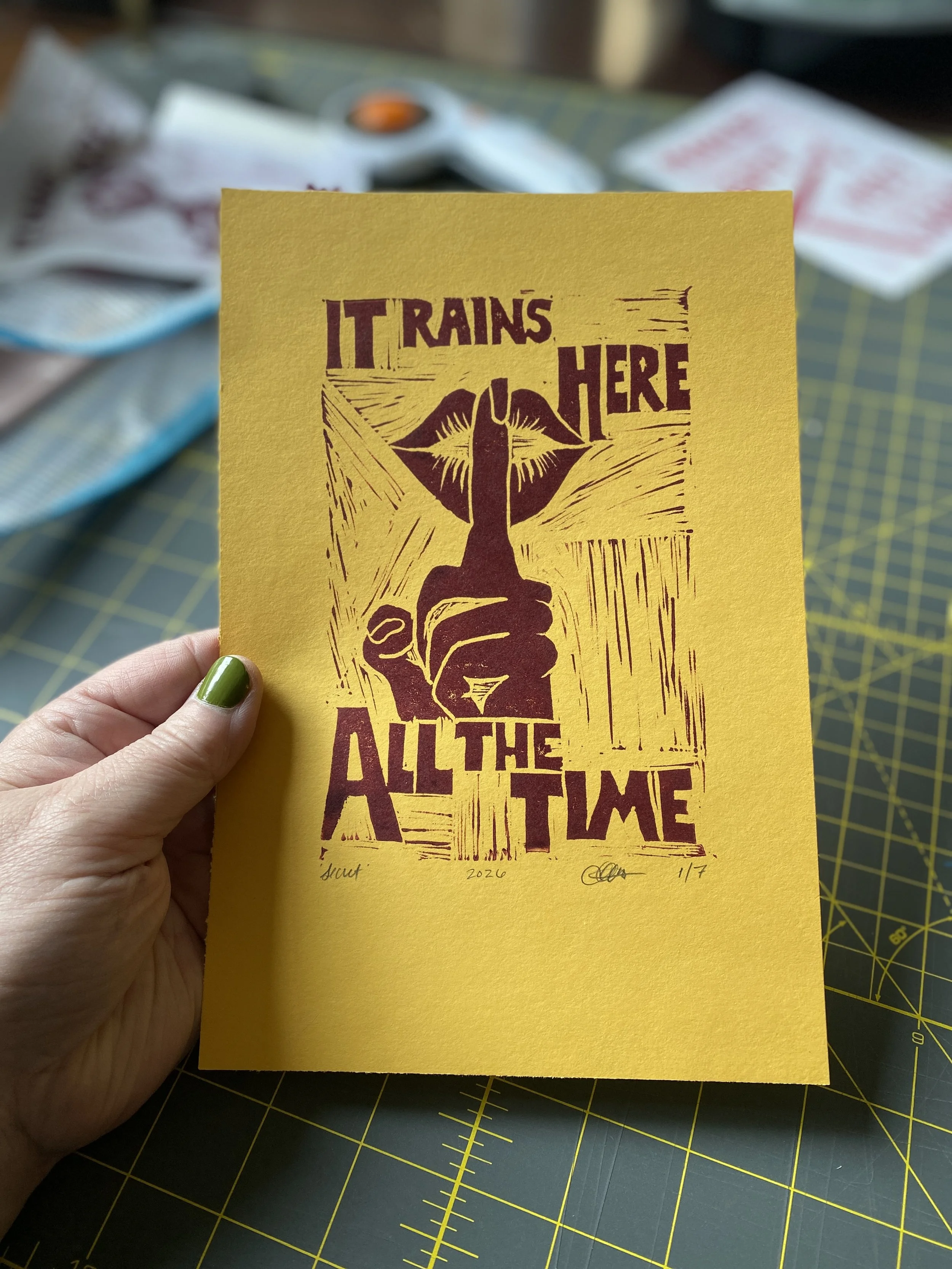 it rains here all of the time pnw pacific northwest art secret tourists it's sunny all of the time block print plum yellow blue lips shhhhhhhhh shush can you keep a secret don't say anything