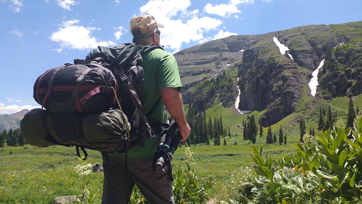With a tripod on the Tripod Suspension Kit, Mike easily strapped his tent and sleeping bag onto the pack's removable sling 