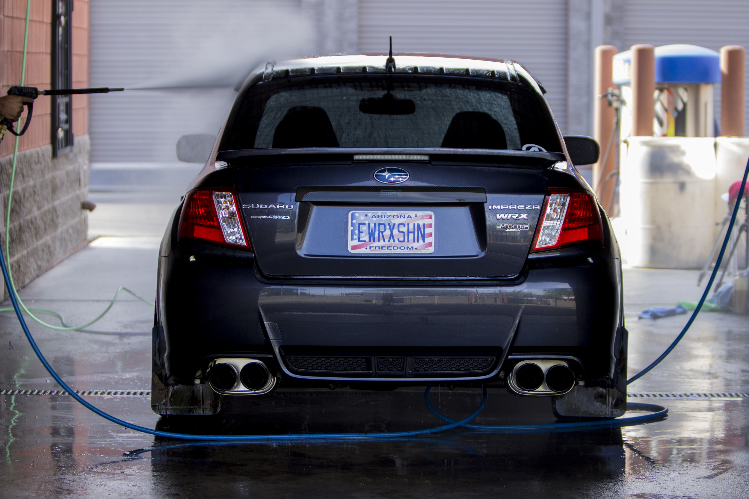 Elliott spraying down his Subaru WRX.