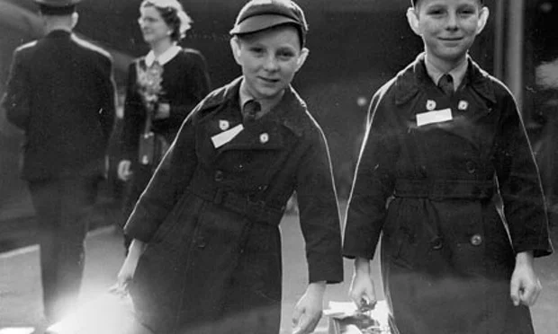 Ten-year-old twins Brian Thomas Sullivan (left) and Kevin James Sullivan from Islington, London, carry their luggage to the boat train at Liverpool Street station bound for Auckland, New Zealand, under the Child Migrant programme. Photograph: AP