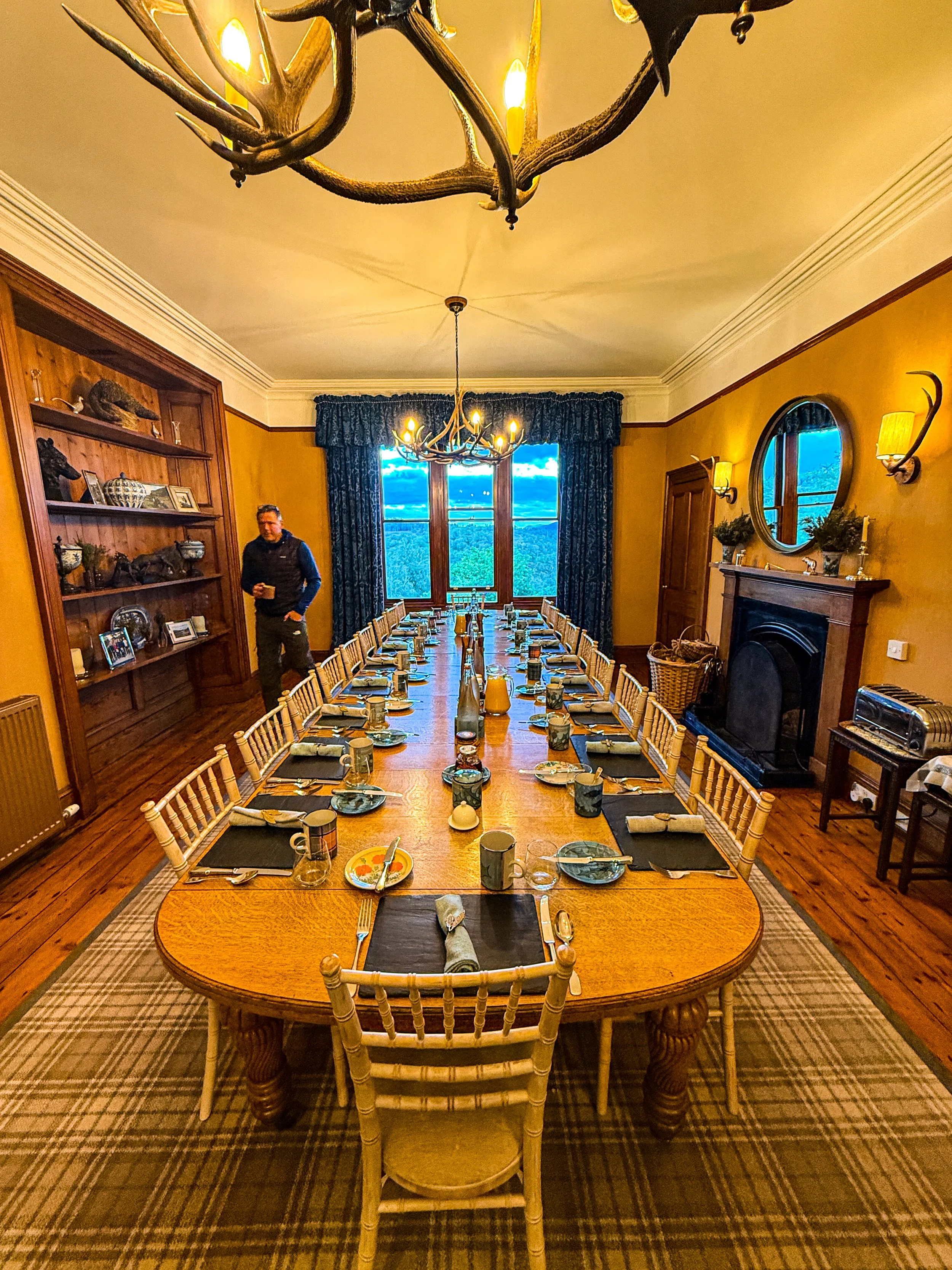 Large dining table inside Alladale House in the Scottish Highlands, where the Rhone Clothing fashion shoot crew gathered for evening meals.