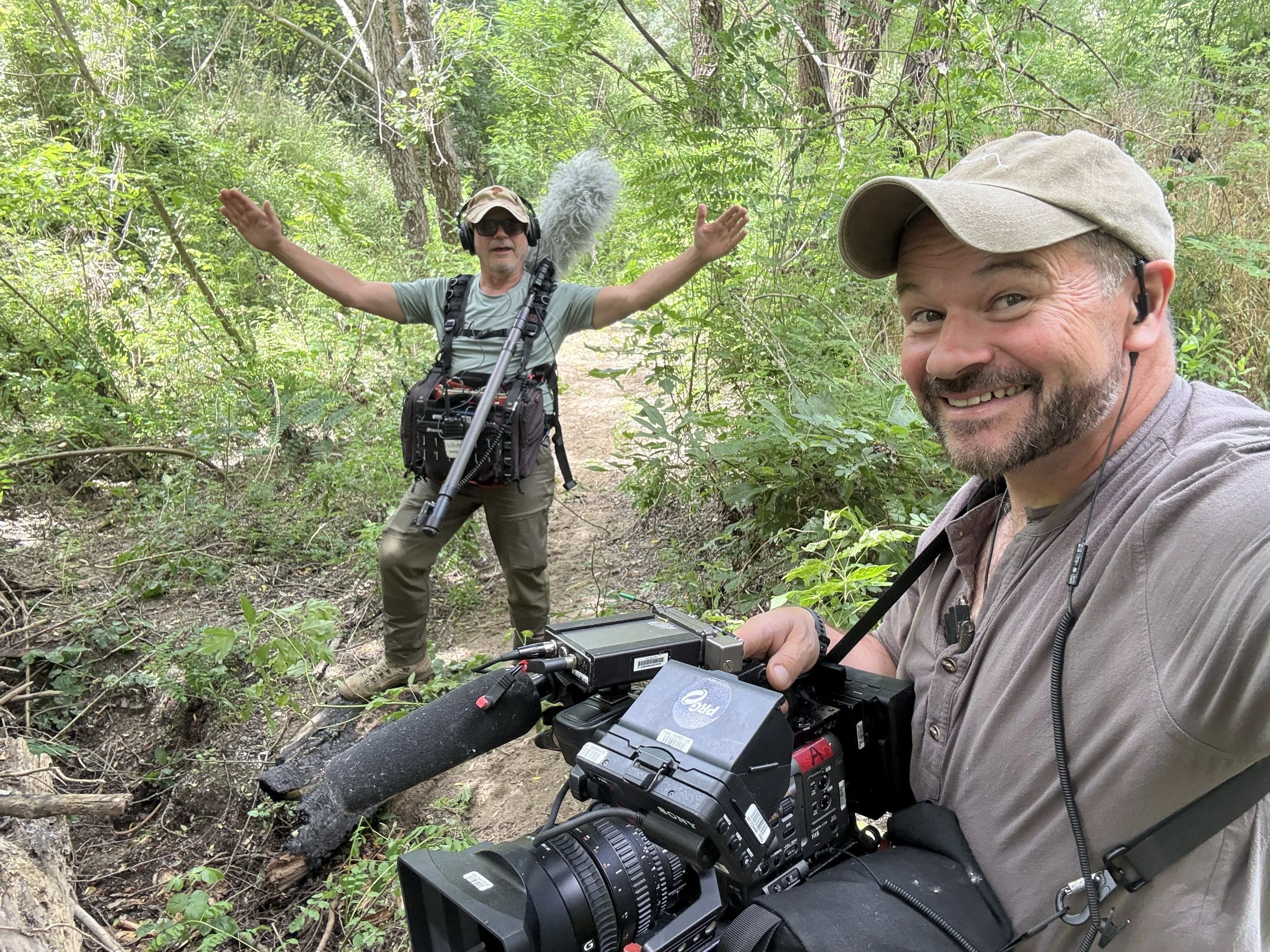 Sound recordist Stephen Crowley with his audio equipment and camera operator Kirk Watson with a Sony FX6 during filming of Naked and Afraid in Bulgaria.