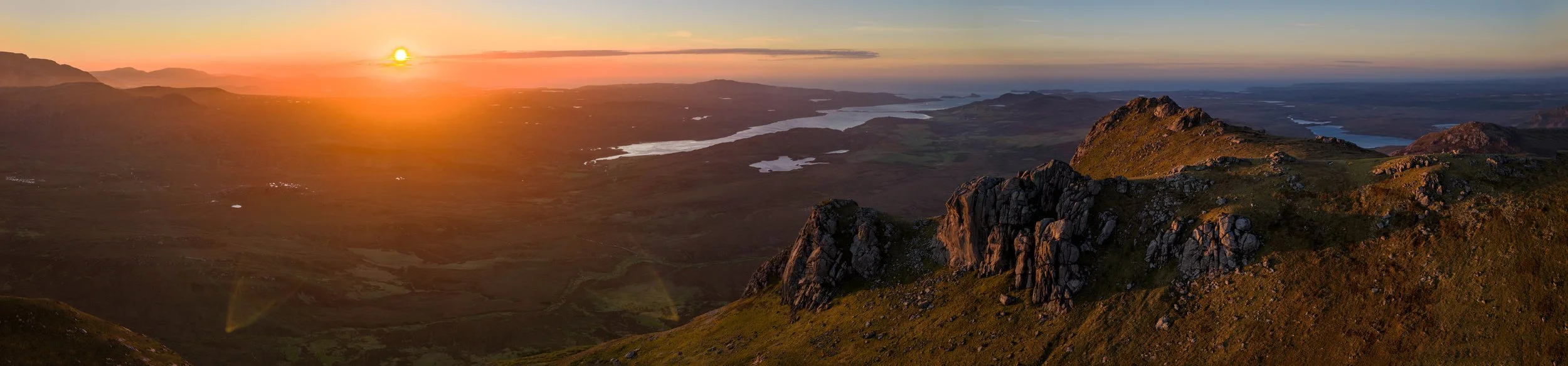 Aerial view of Ben Loyal at sunset in the Scottish Highlands, filmed by drone operator Kirk Watson