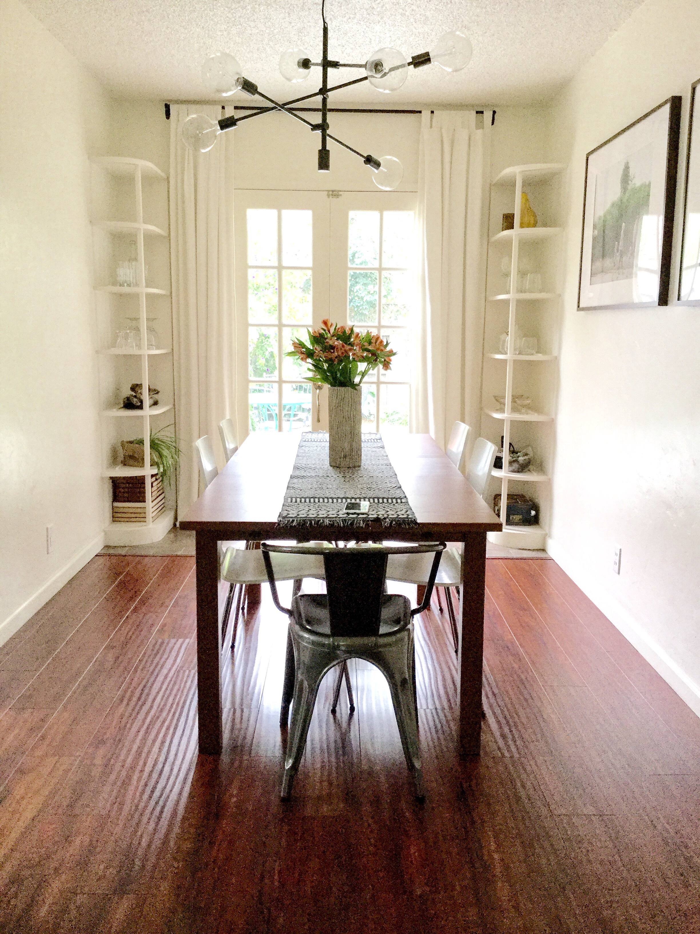 Tidy craftsman built-ins and french doors open up to the backyard. 