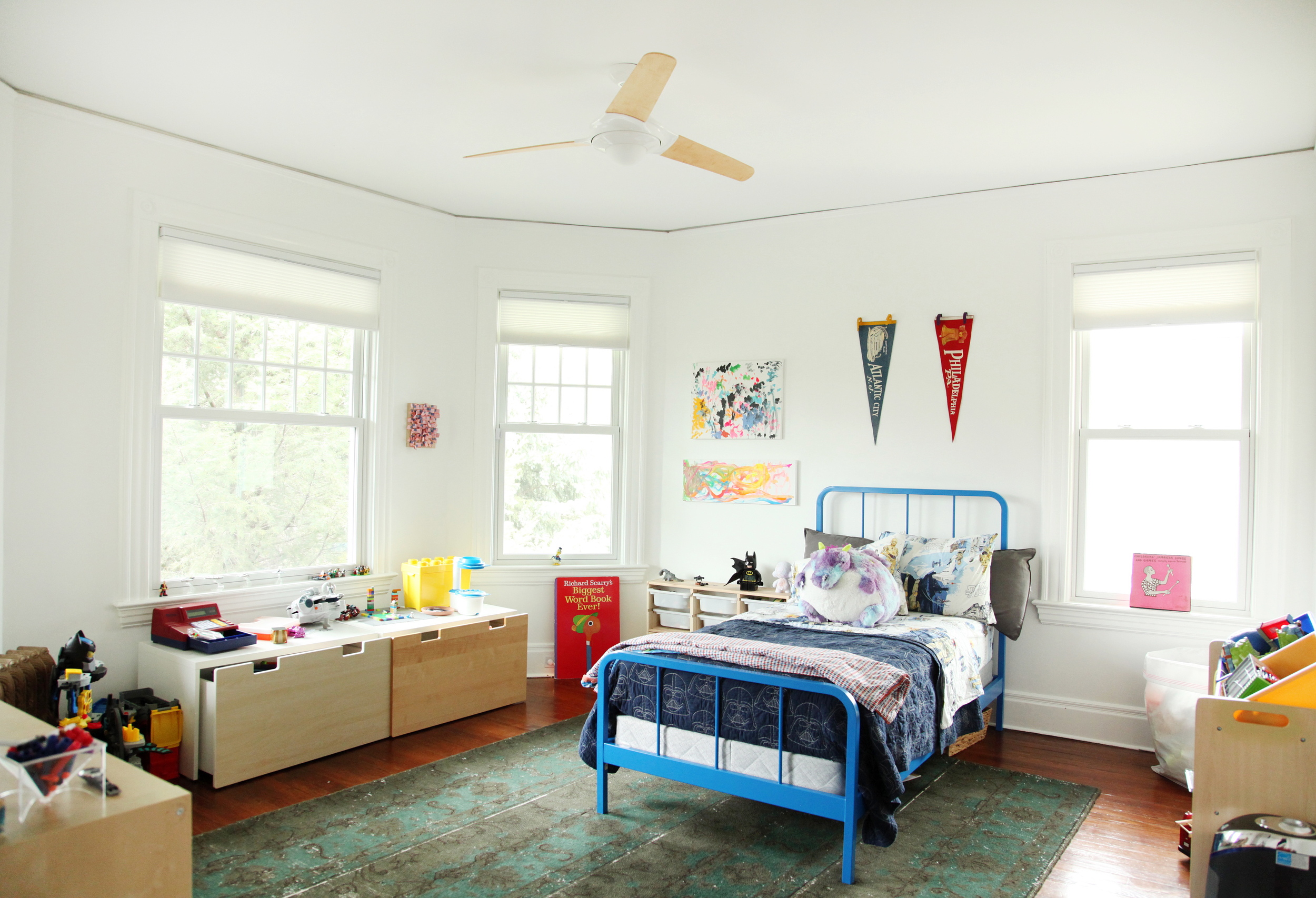  Desmond's room- " as tidy as a five year old boy's room can b e"-&nbsp;old pennants that used to hang in Thomas’ office along with Desmond’s own art hang on the walls. Bed is   Land of Nod .  