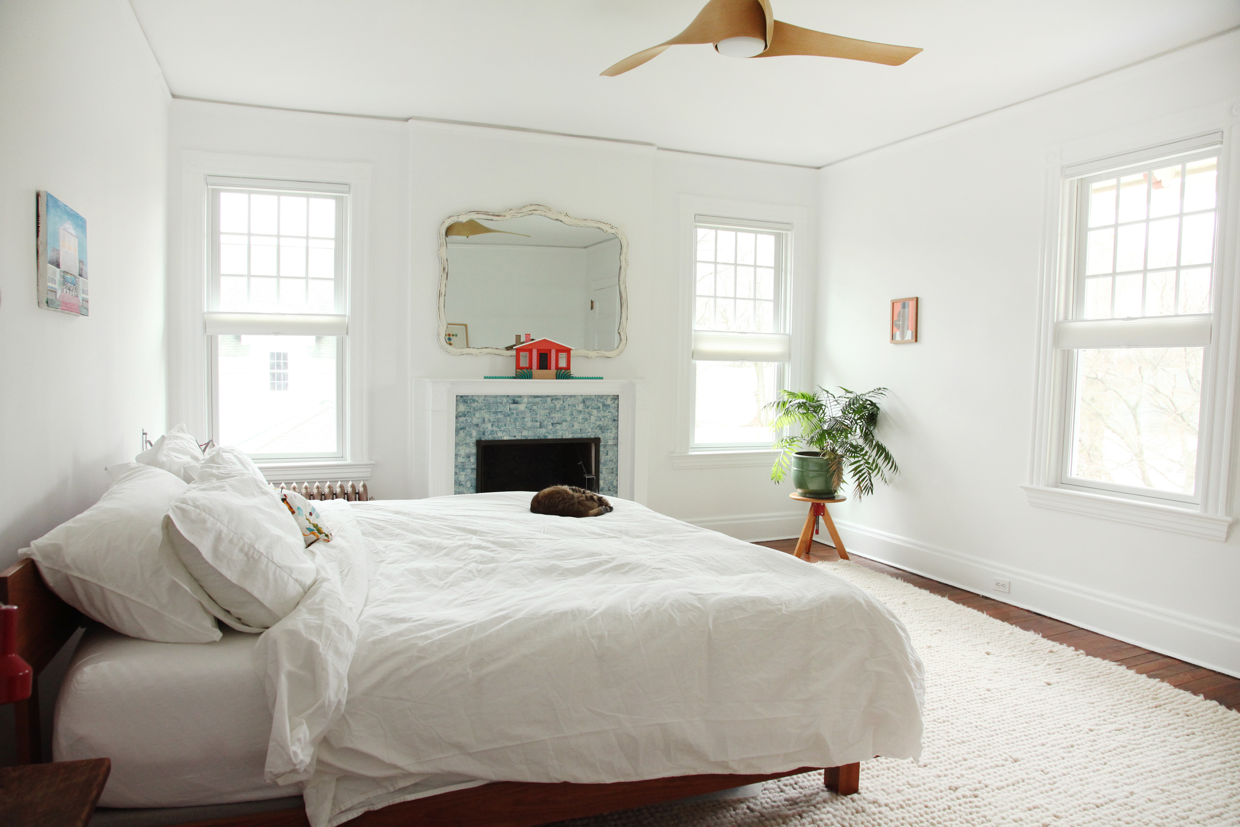   "I like our bedroom to be minimal, I find it soothing. &nbsp;The master bed is from  Room and Board  with our other cat Lloyd Christmas aka 'Panties.'&nbsp;&nbsp;Night stands are made of old barn wood that Thomas cut to size and the shelf brackets 