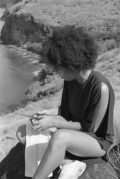 Laurence wearing her THEMIS earrings. Photographed sharing an orange, Martinique, September 16.