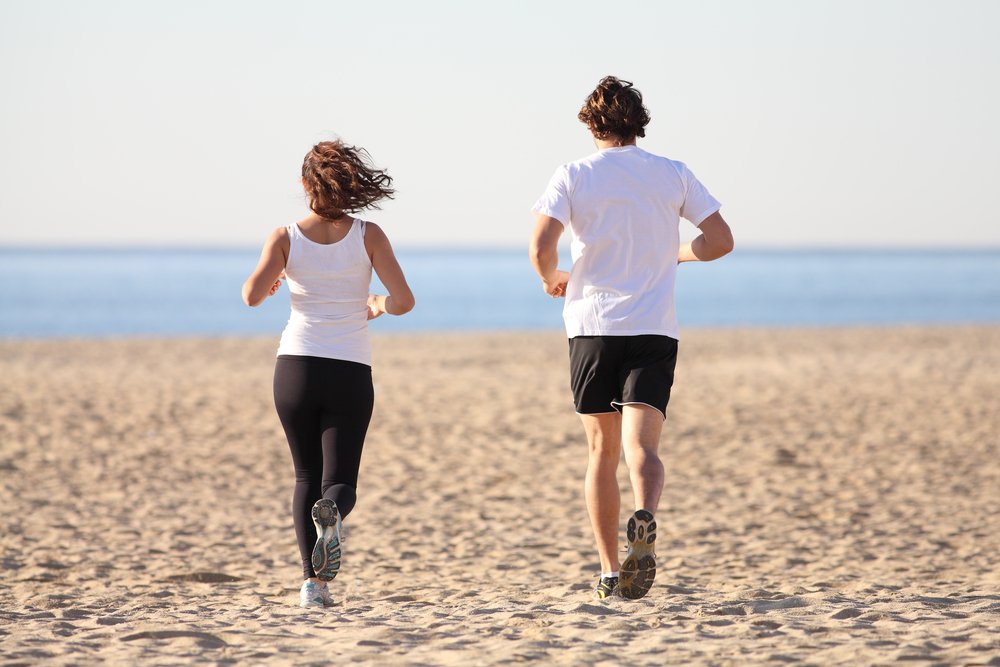 Image of runners on the beach