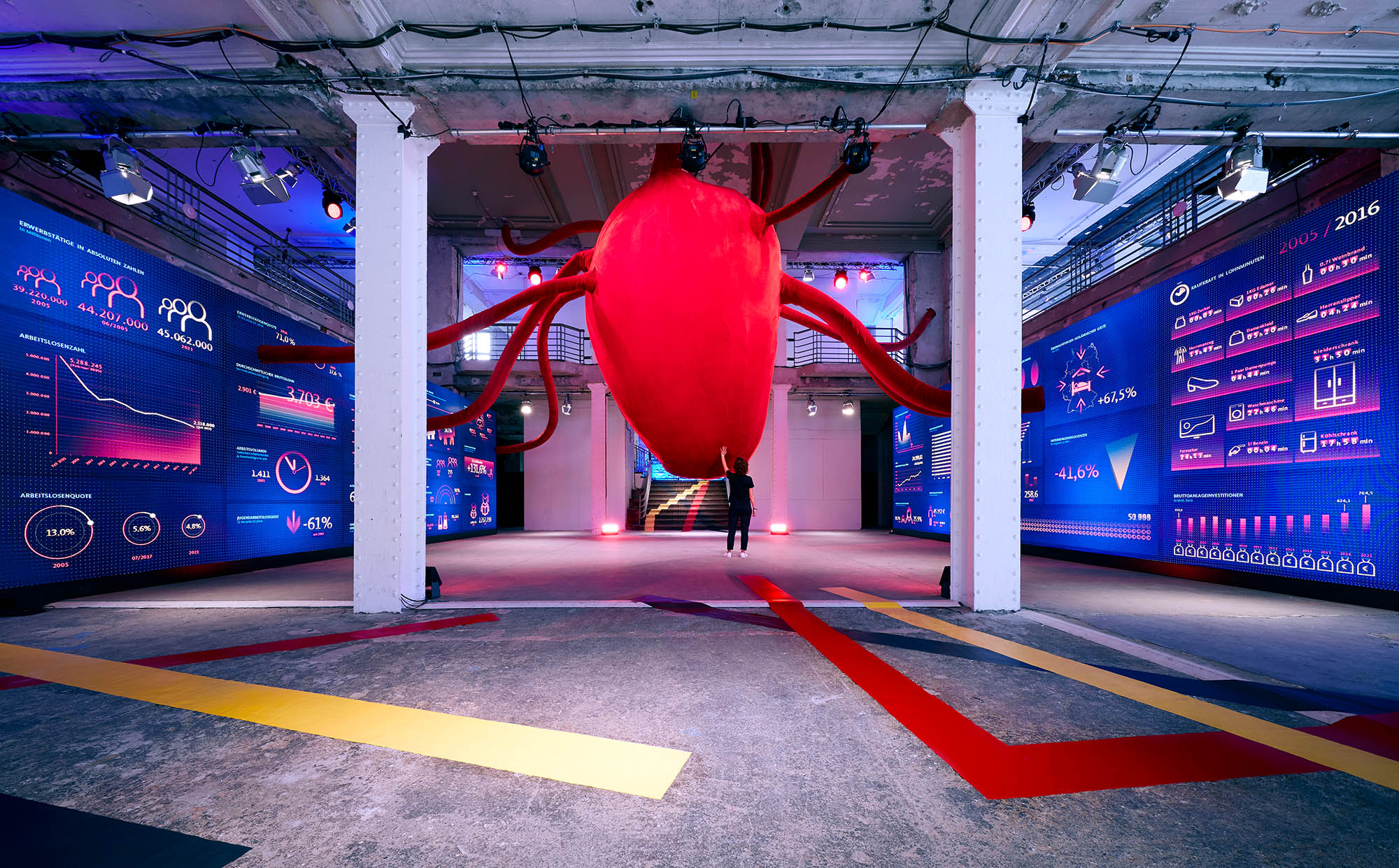 "The Heart of the German Economy". A 7m x 3m tall heart, made of red velvet is literally the heart of the house. It's accompanied by 2 10m x 3m large display walls showing the power of the German economy. Photo: Anne Deppe