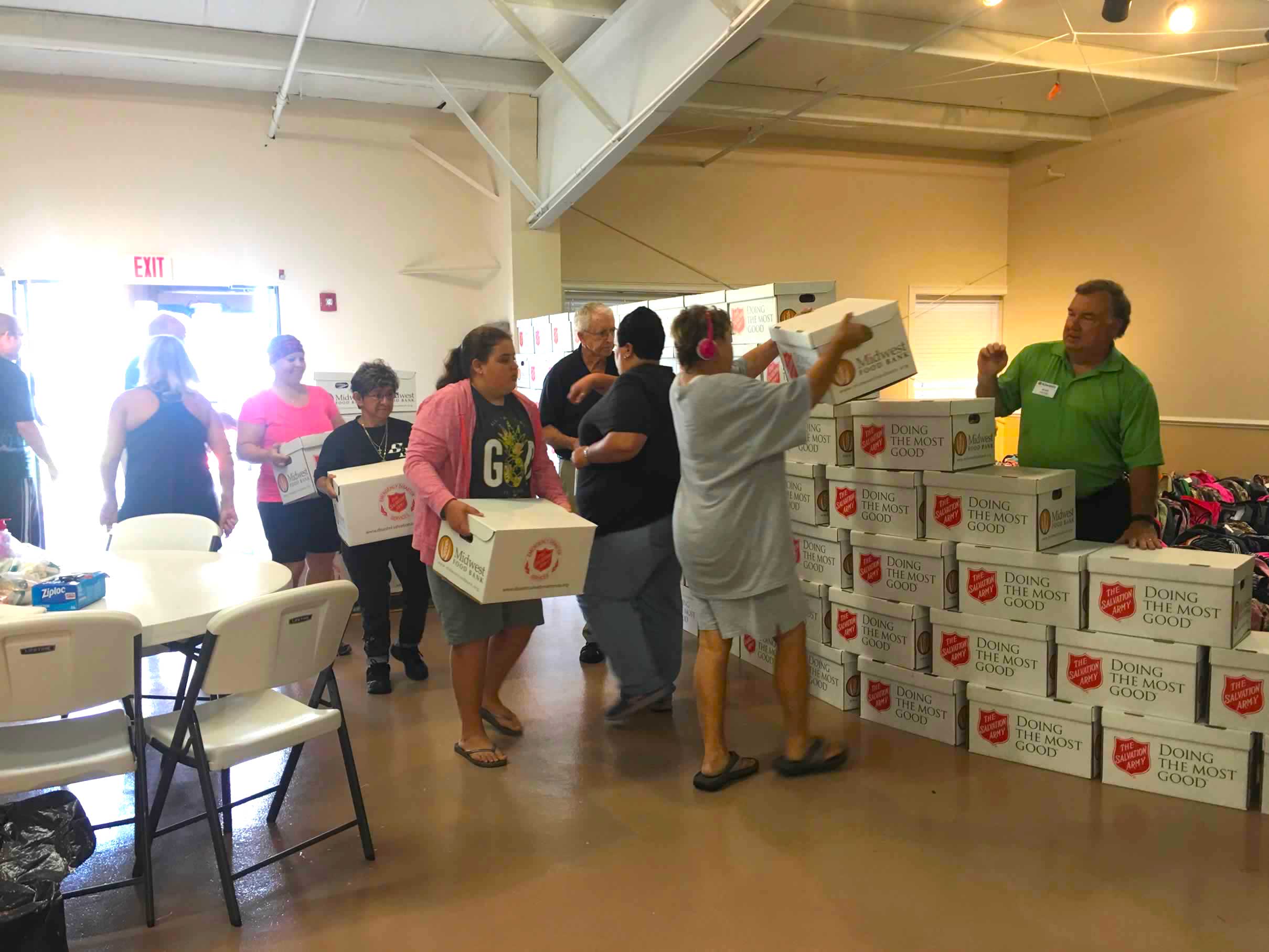  Volunteers create wall of food donations from the Salvation Army, one of the Kiwanis partners. 