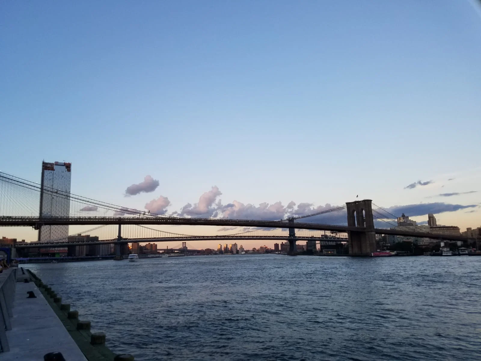  The Brooklyn Bridge is one of the oldest roadway bridges in the United States. Started in 1869 and completed fourteen years later in 1883, it connects the boroughs of Manhattan and Brooklyn , spanning the East River . It has become an icon of New York City and was designated a National Historic Landmark in 1964 and a National Historic Civil Engineering Landmark in 1972.