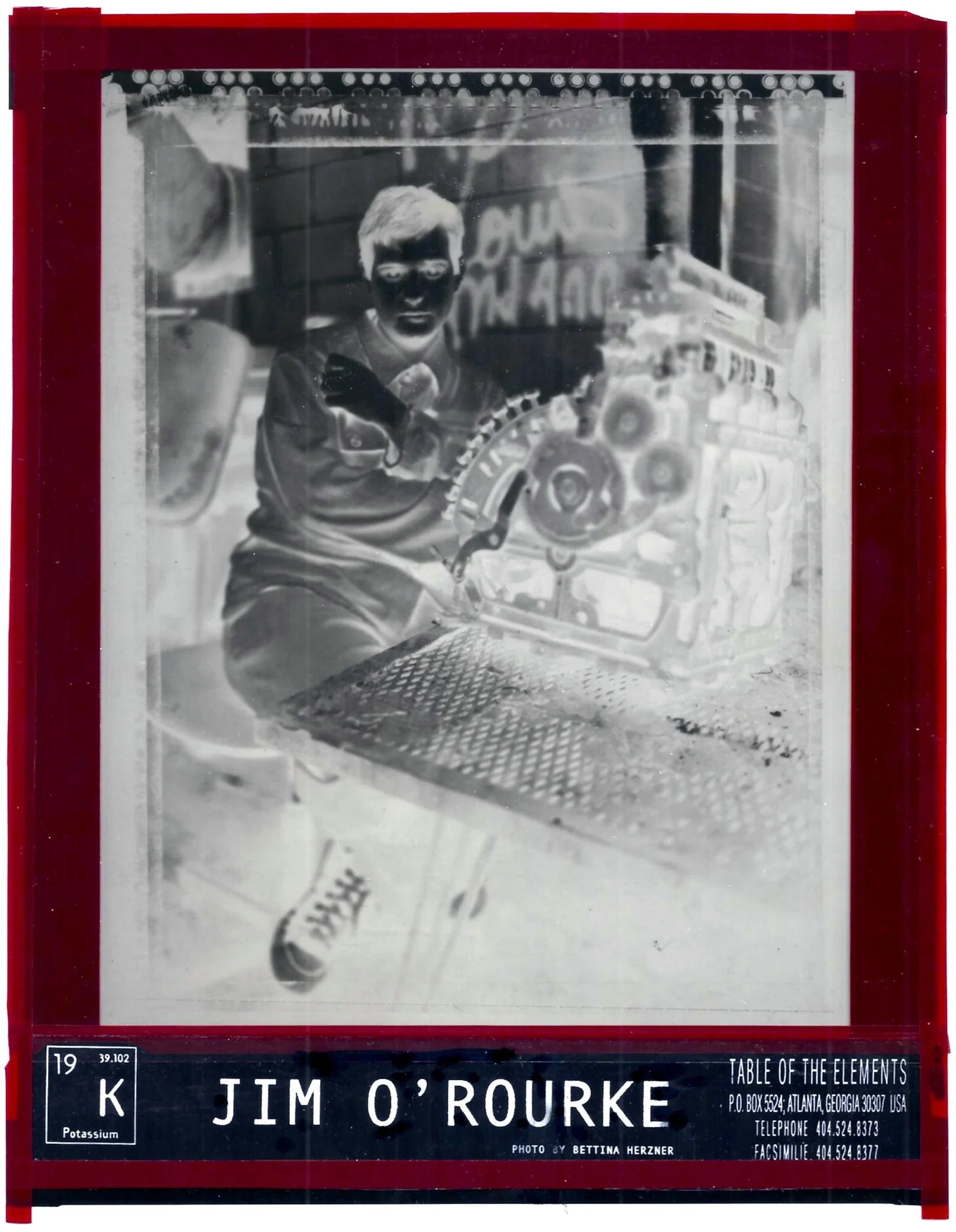   "We put chemicals in one end so our customers can get memories out the other."  ― unidentified former Kodak employee  Photograph: Bettina Herzner, 1994  Contact negative from paper print, 8” x 10”   