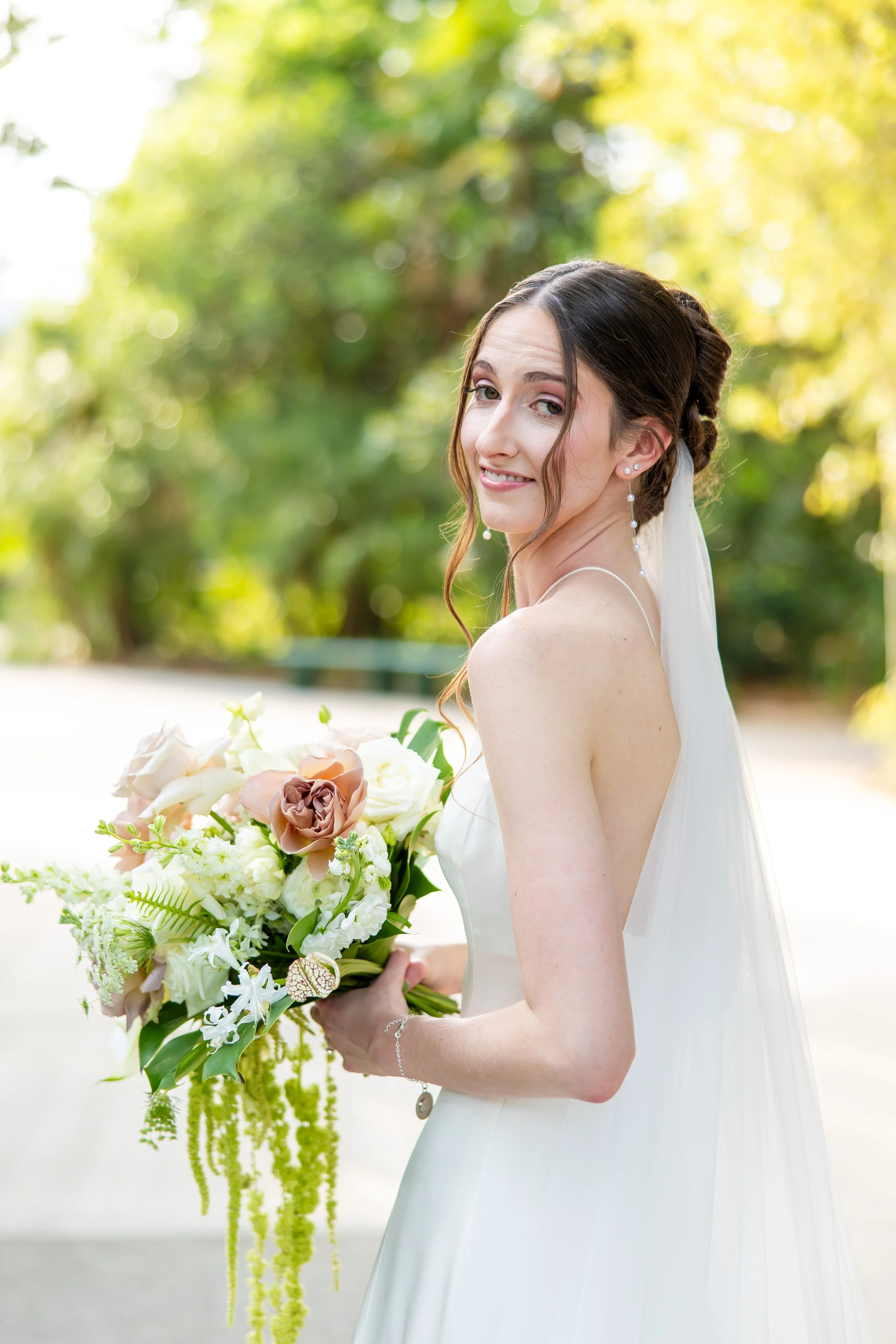Bride Delaney wearing a romantic rose bridal makeup look and elegant updo by Paula J Fields Beauty for her Riverbanks Zoo wedding in Columbia, SC.