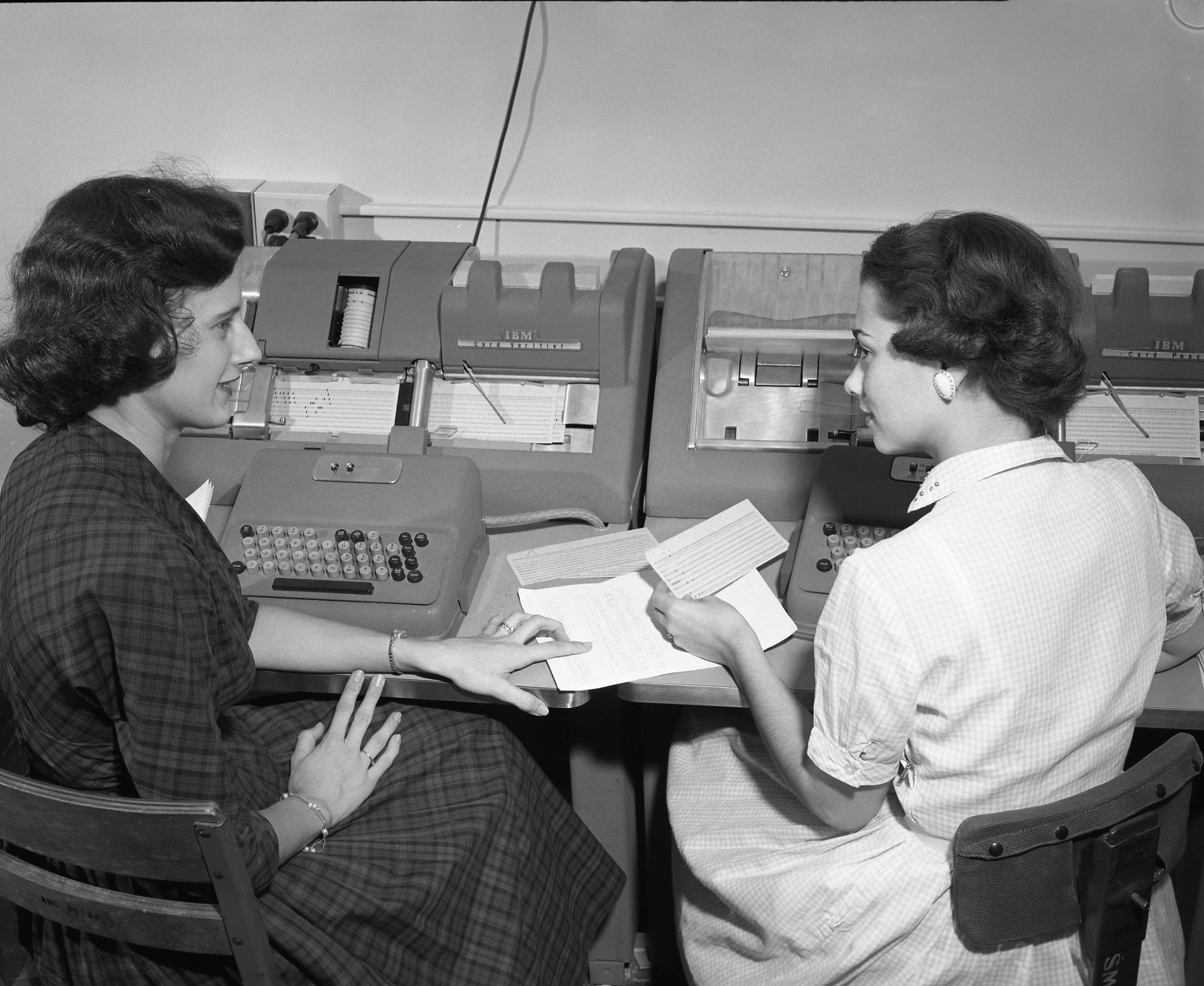 Two women discussing their work while entering data onto punched cards at Texas A&M in the 1950s. Cushing Memorial Library and Archives/Wikipedia Commons (CC BY 2.0)