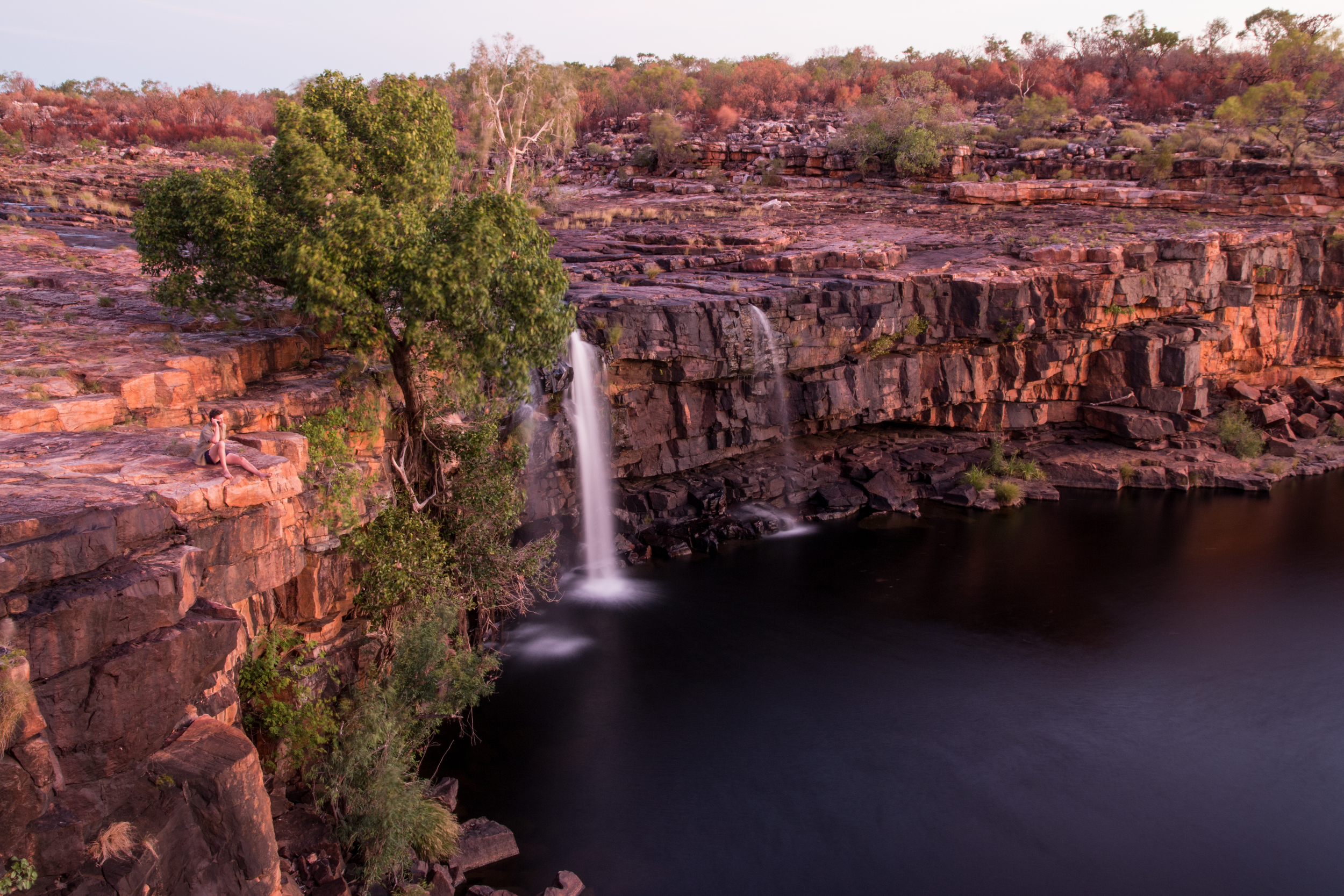 James Shelley makes a routine evening call via satellite phone in spectacular surrounds. © Matt Le Feuvre.