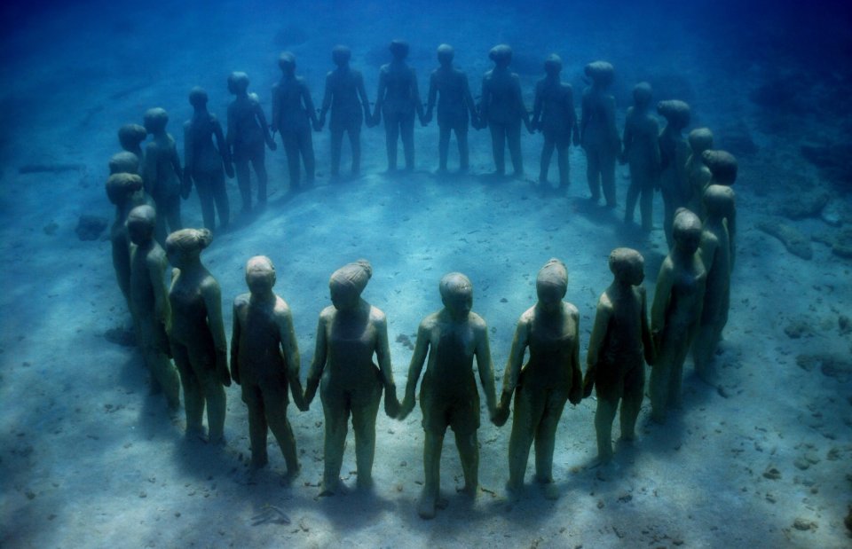 Jason deCaires Taylor’s circle of underwater guardians is providing much-needed relief for the reef in which it stands. © Jason deCaires Taylor (used with artist’s permission)