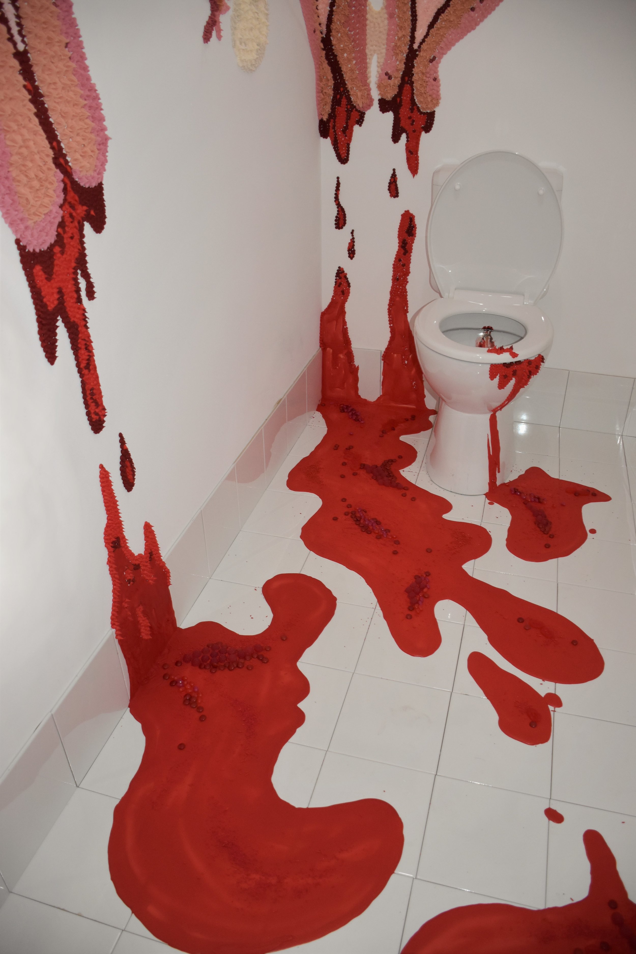 “We’re trying to make it delicious as well as confronting.” Cassandra Chilton and Molly O’Shaughnessy used 30 kilograms of royal icing to graffiti toilet stalls with uteruses and menstrual blood in You Beaut. © Hotham Street Ladies (used with permission)