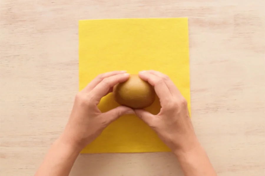 Step 1: Cut your yellow paper to an appropriate size (enough to cover the surface of the fruit).
