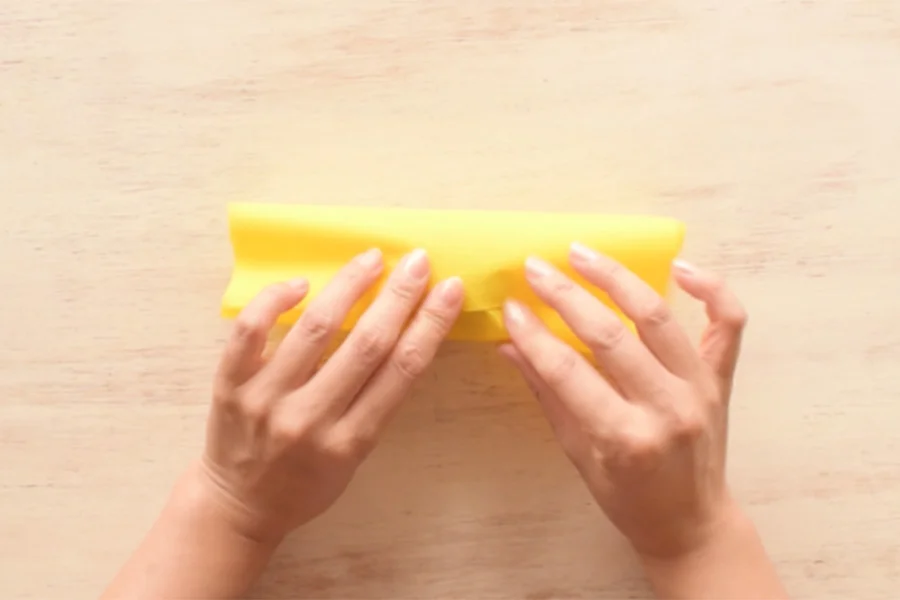 Step 2: Wrap the paper around the fruit (tape to close the end if your like).
