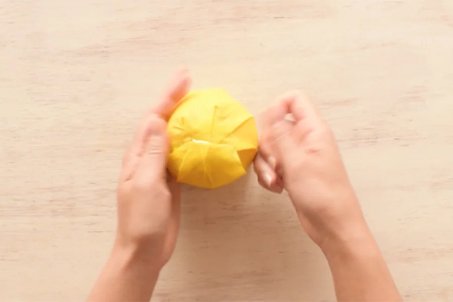 Step 3: Create pleats (gathers) toward the center to close the top and bottom ends. Tape to secure.