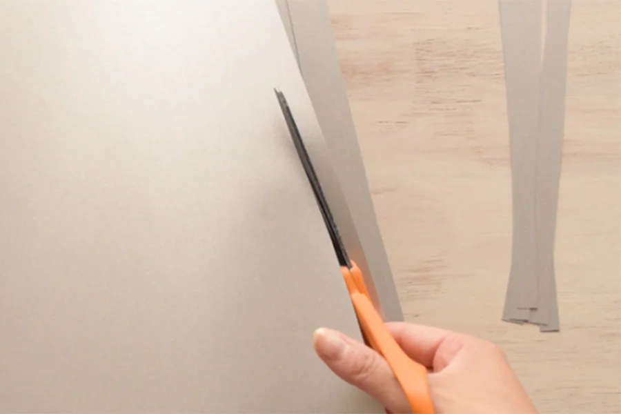 Step 1: Cut strips with silver or grey paper. The width of the strips should match to the size of your fruits. The length of the strips should be enough to wrap around the fruits.