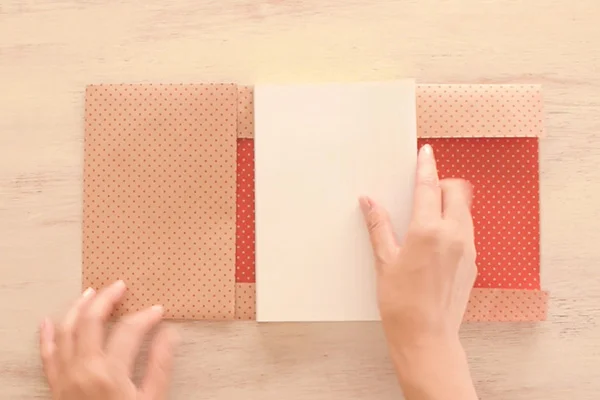Step 3: Fold the left side paper (or whichever the front side of your book) at the width of the book.