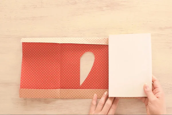 Step 9: Fold back the creases and wrap the paper around the book.