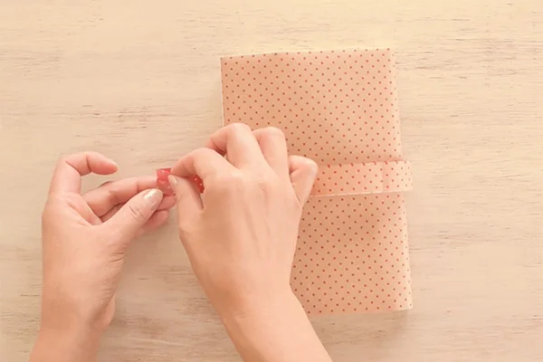 Step 11: Put the paper belt through the slit, cut the ends and close with a glue dot.