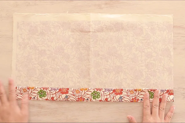 Step 2: Place the book at the center. Mark at the bottom of the book, then fold up at the mark.