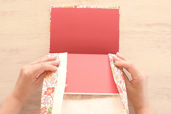 Step 13: Fold the top and bottom papers of the other side of the book.